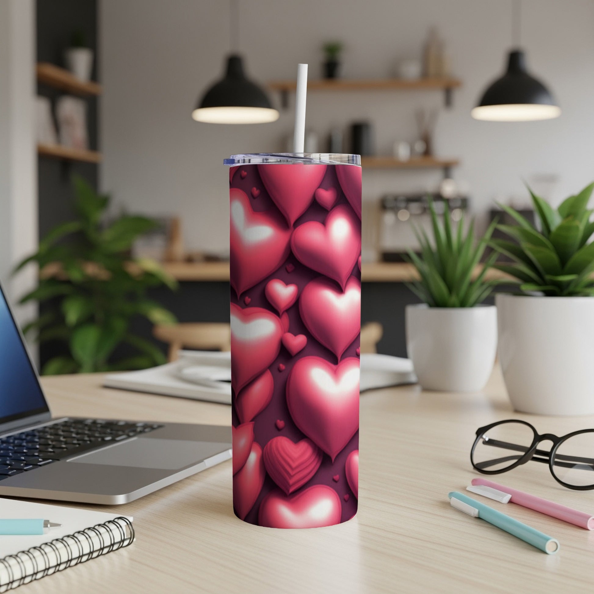 Tumbler with scattered 3D pink and red hearts against a dark red background.