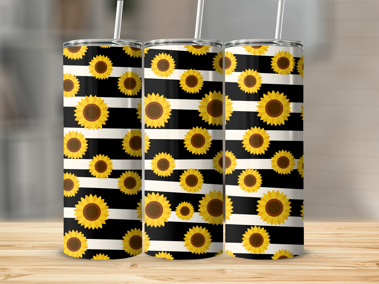 Three stainless steel tumblers with sunflowers on black and white stripes.
