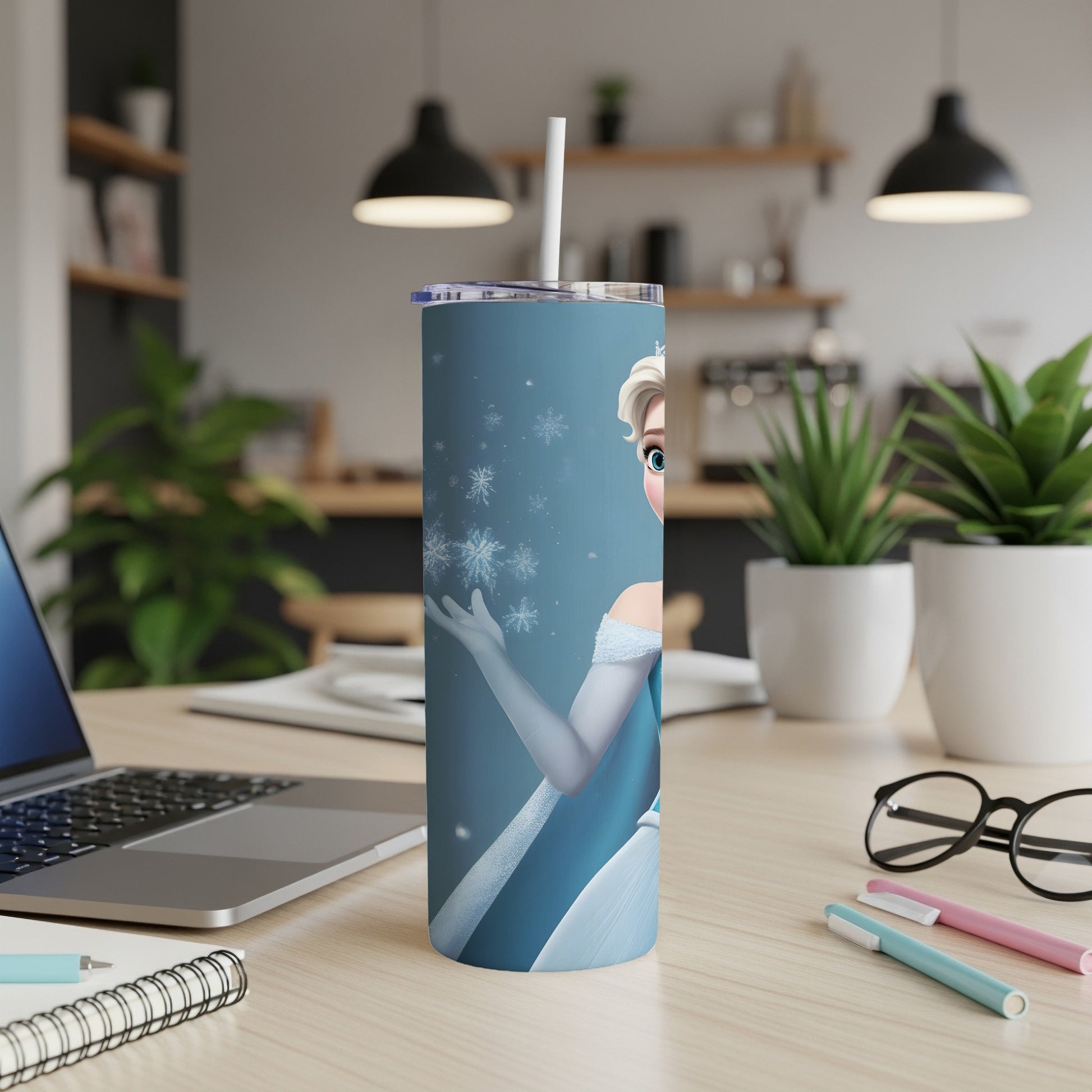Elsa from Frozen on a blue tumbler with snowflakes and a straw.
