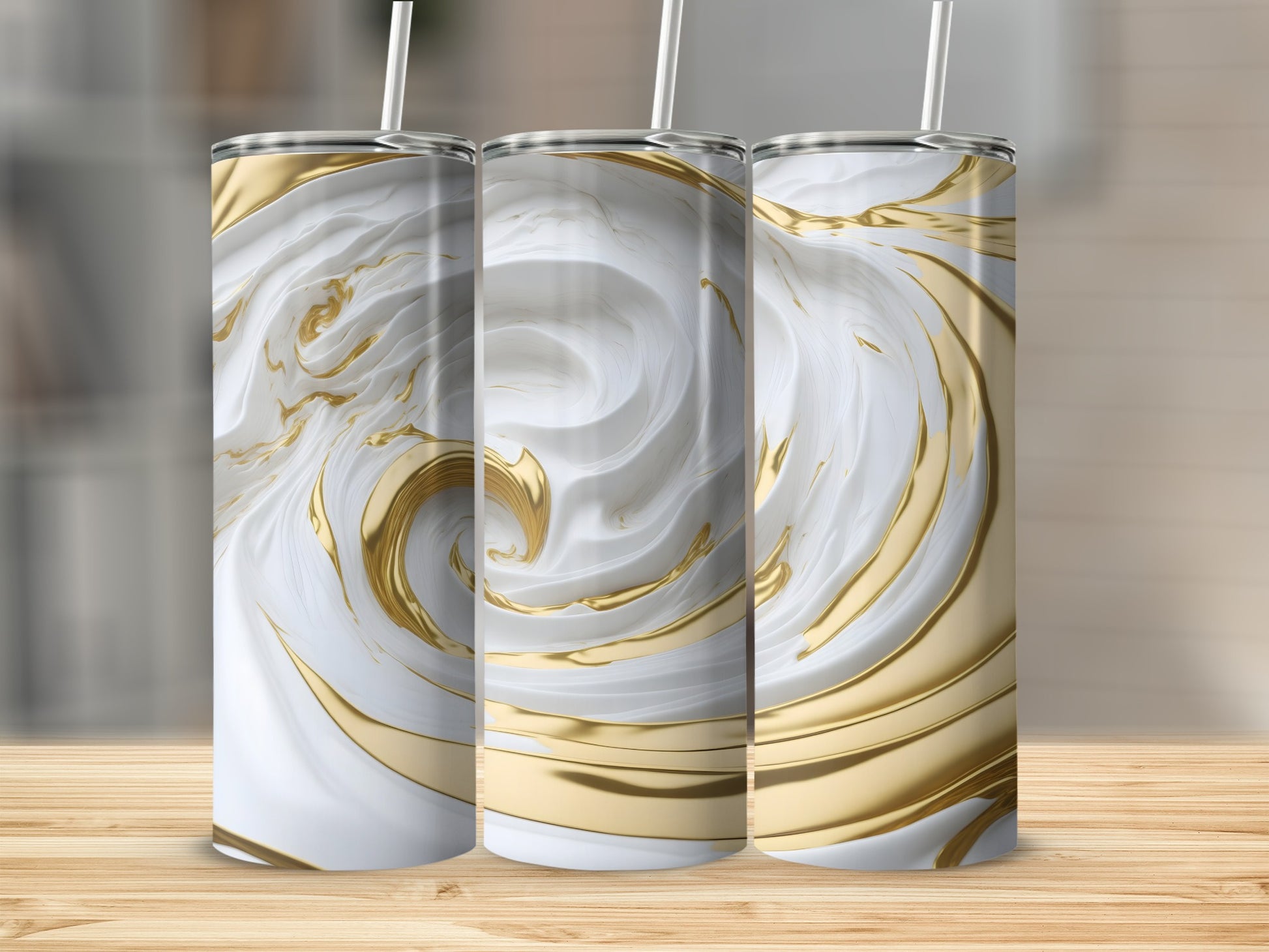 Three white and gold marbled tumblers with straws on a wooden surface.