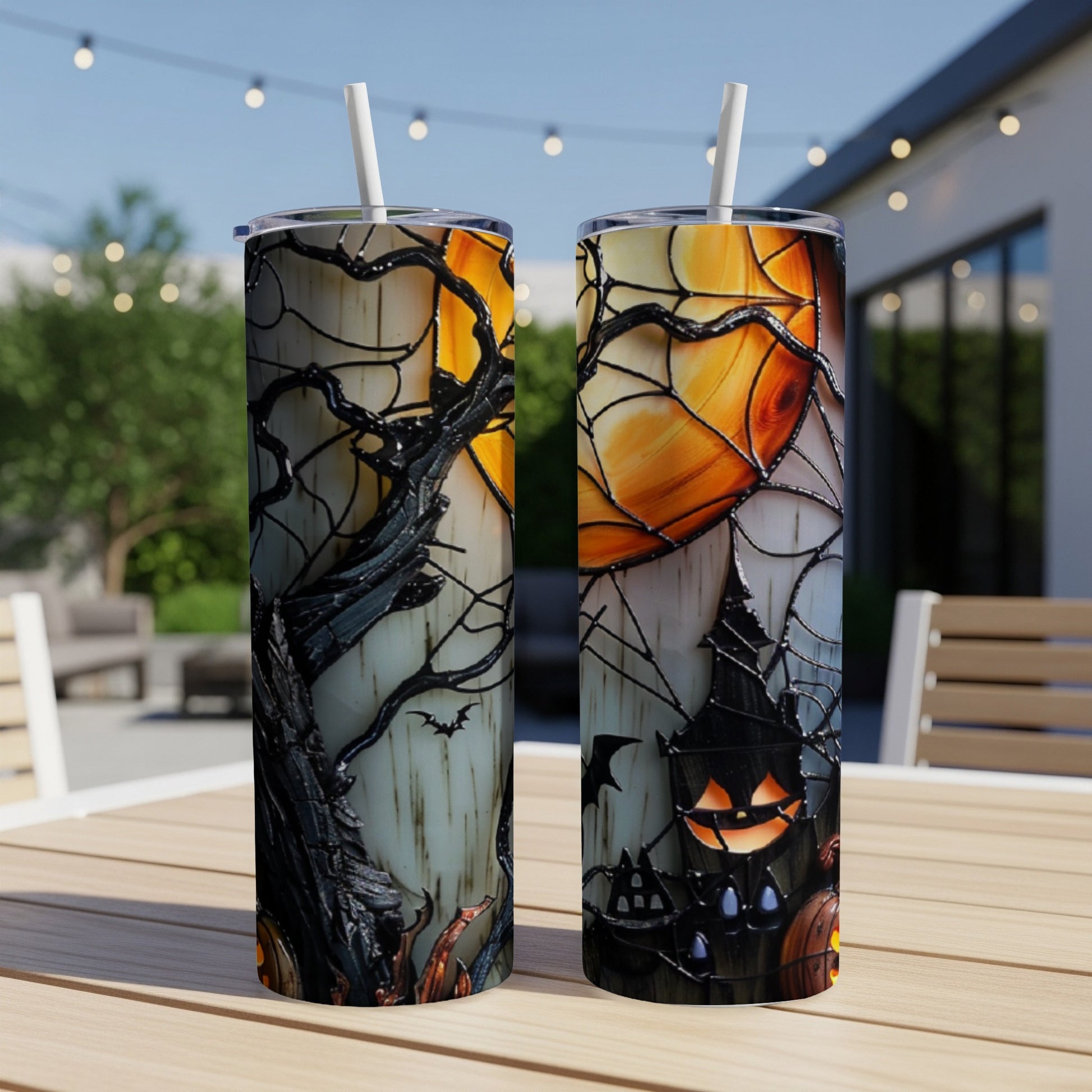 Two Halloween-themed tumblers with stained glass art featuring a spooky house and pumpkins.