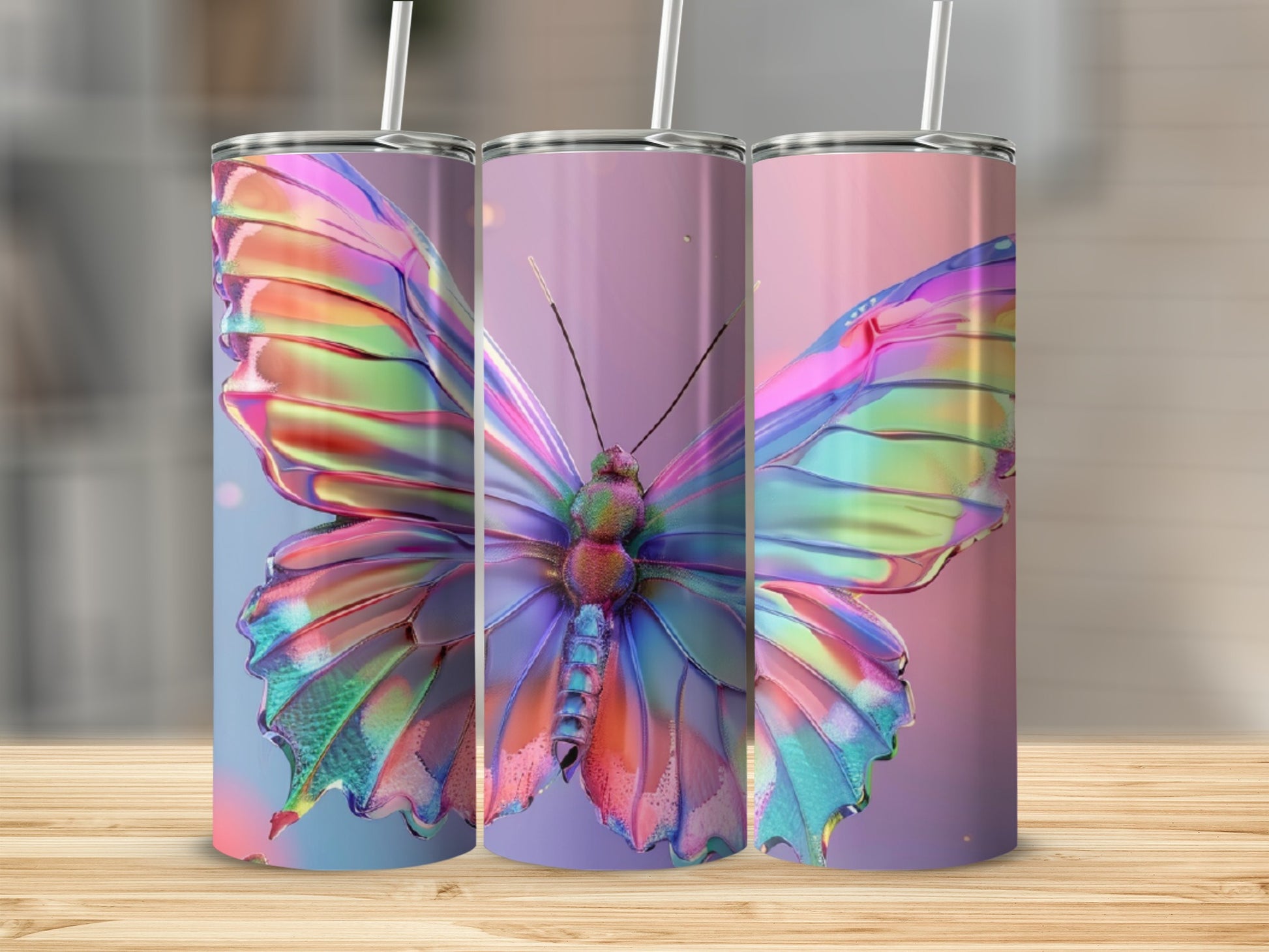 Three tall tumblers with iridescent butterfly designs in a row.