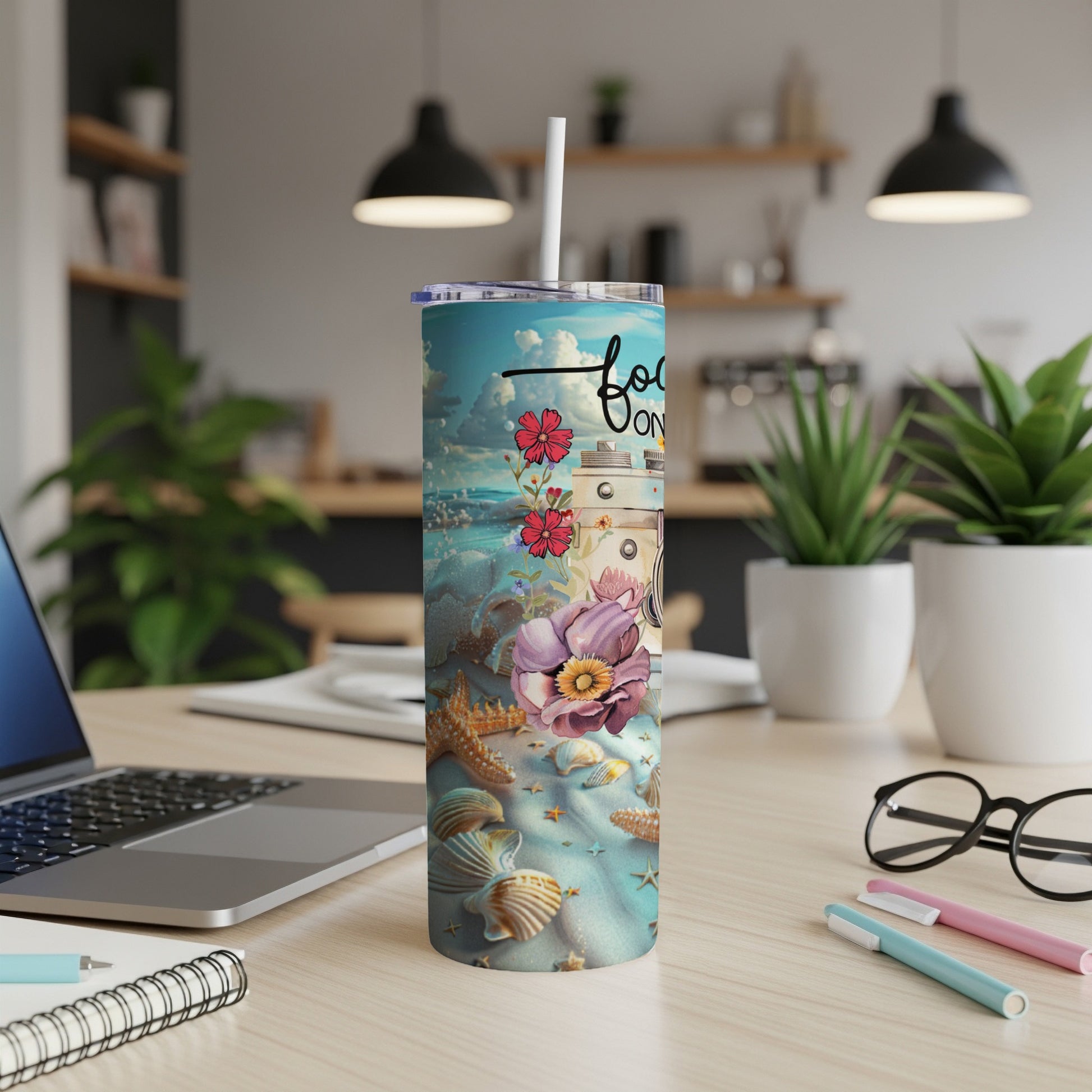 Beach scene with seashells, starfish, and flowers on a travel tumbler.