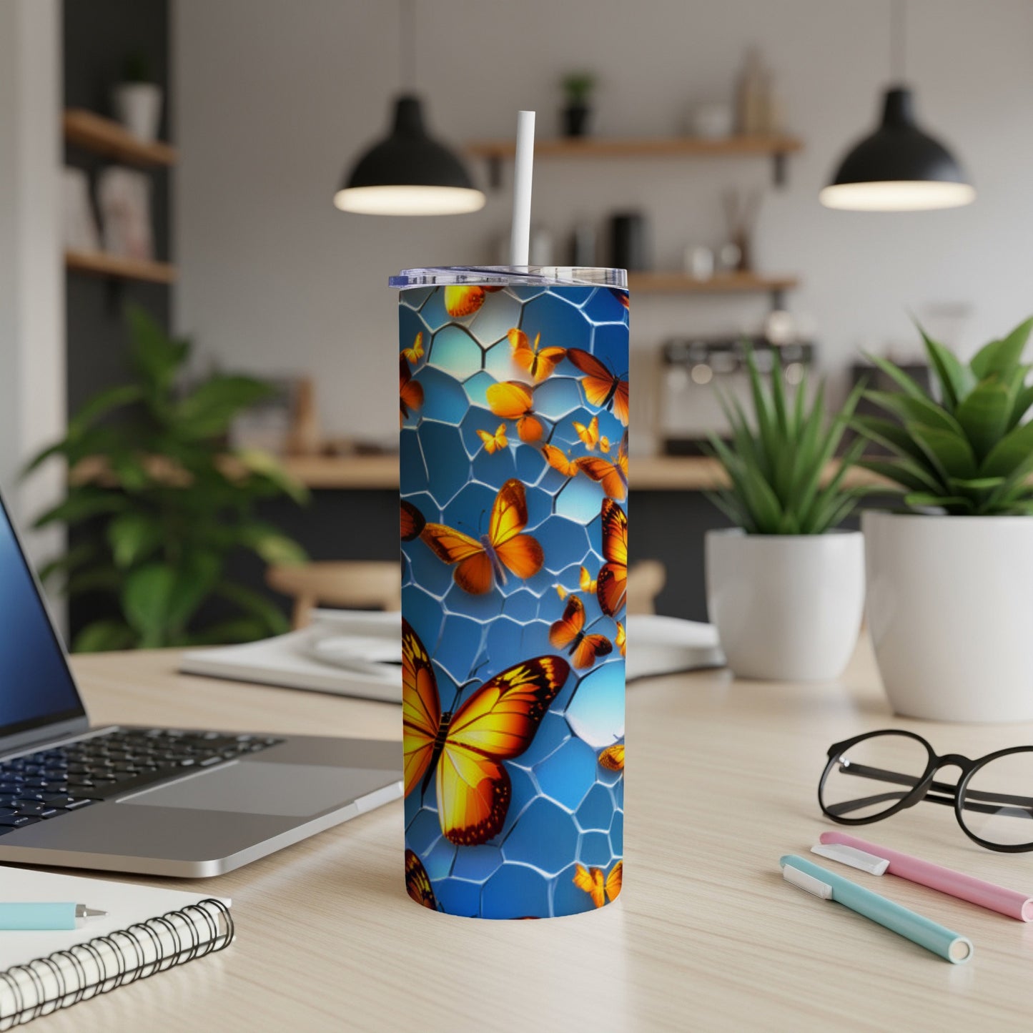 Blue tumbler with orange and yellow butterflies on a honeycomb pattern.