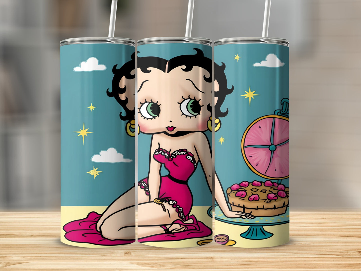 Betty Boop character in pink dress sitting next to a cake.
