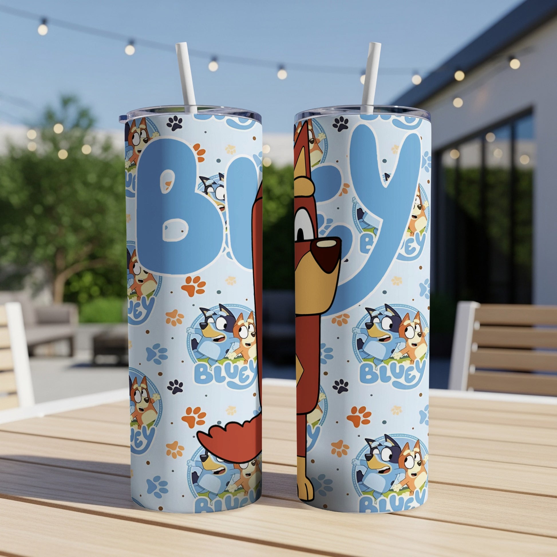 Two Bluey character tumblers with Bluey pattern on a patio table.