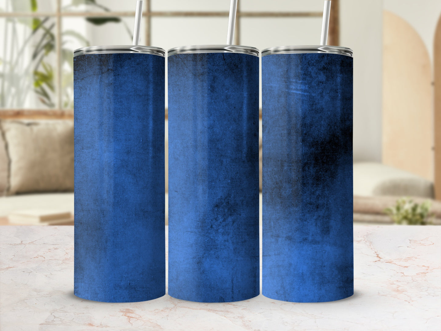 Three stainless steel tumblers with blue distressed texture and silver straws.