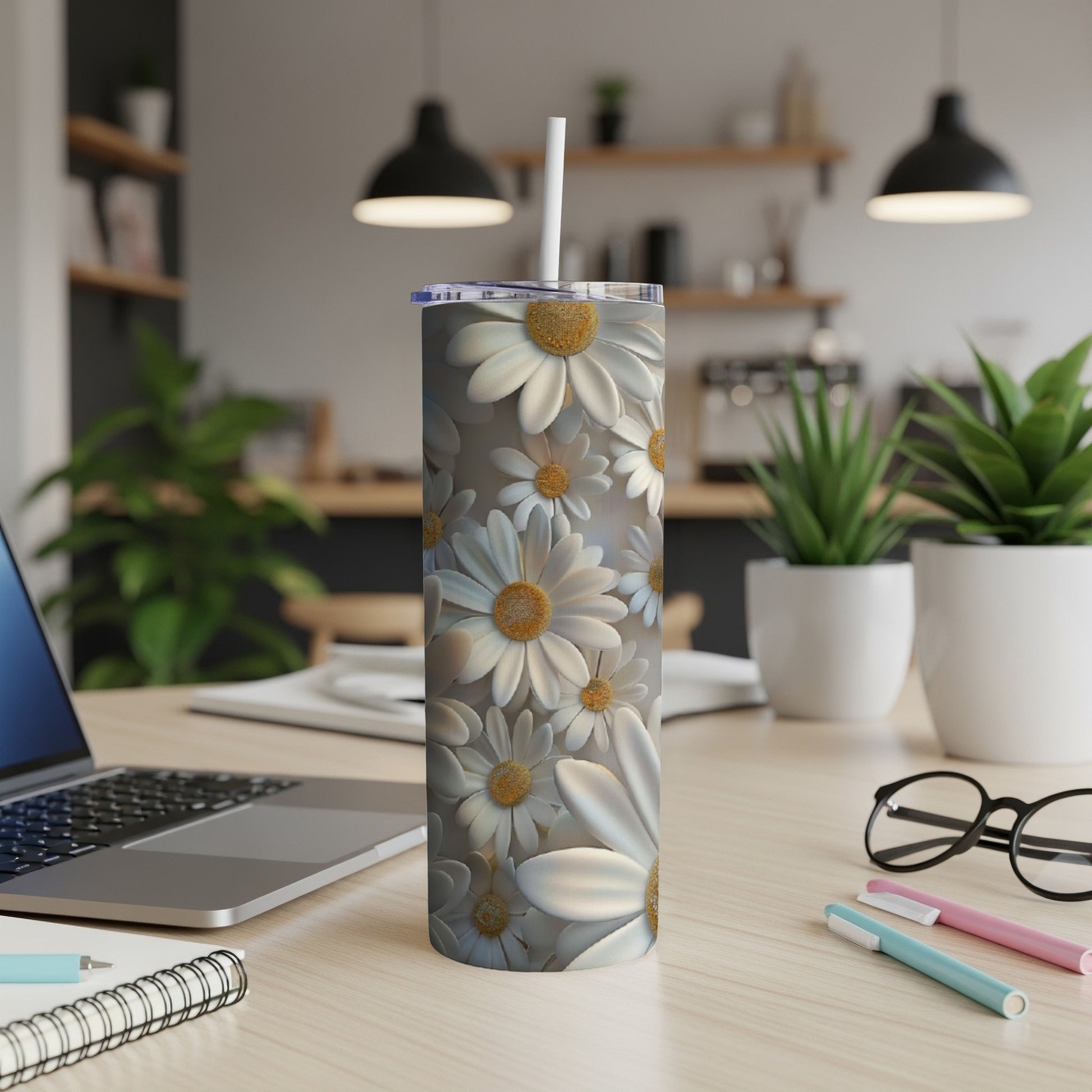 White and yellow daisy pattern on a white stainless steel tumbler with a straw.