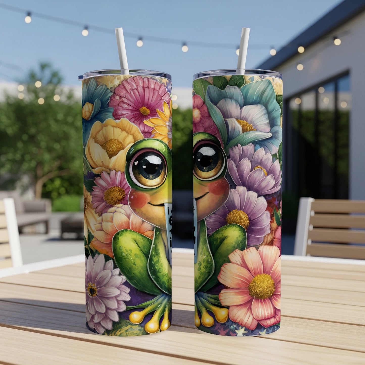 Two tumblers with a happy frog and floral design on a wooden table.