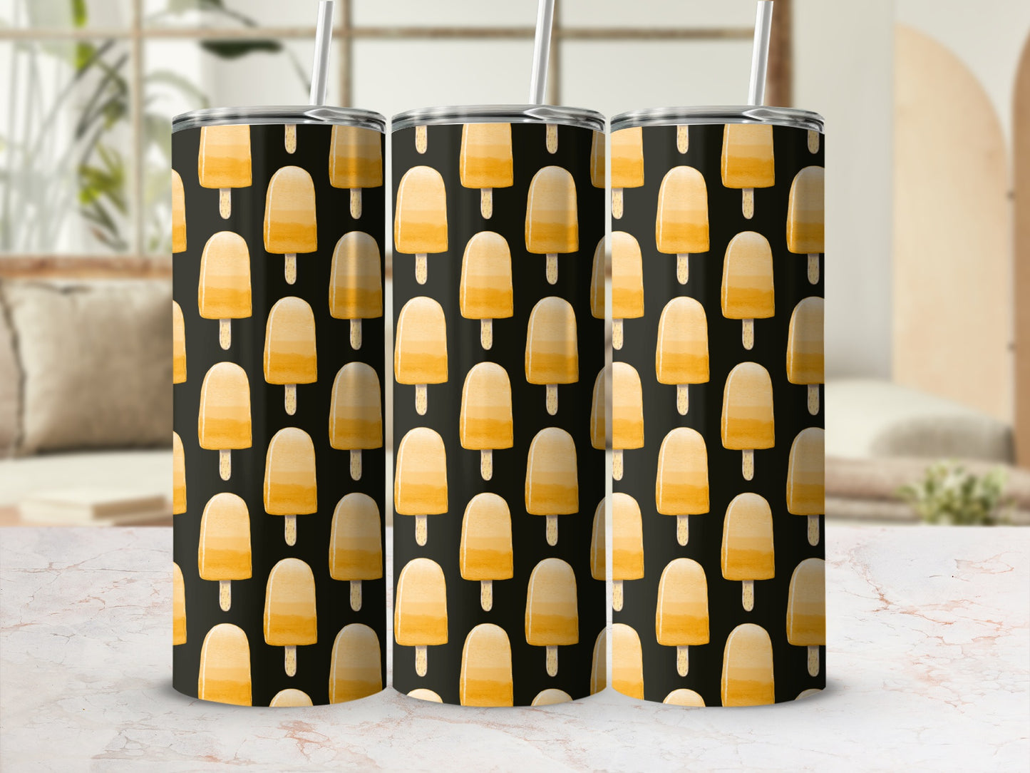 Three tumblers with a pattern of orange popsicle ice cream on a black background.