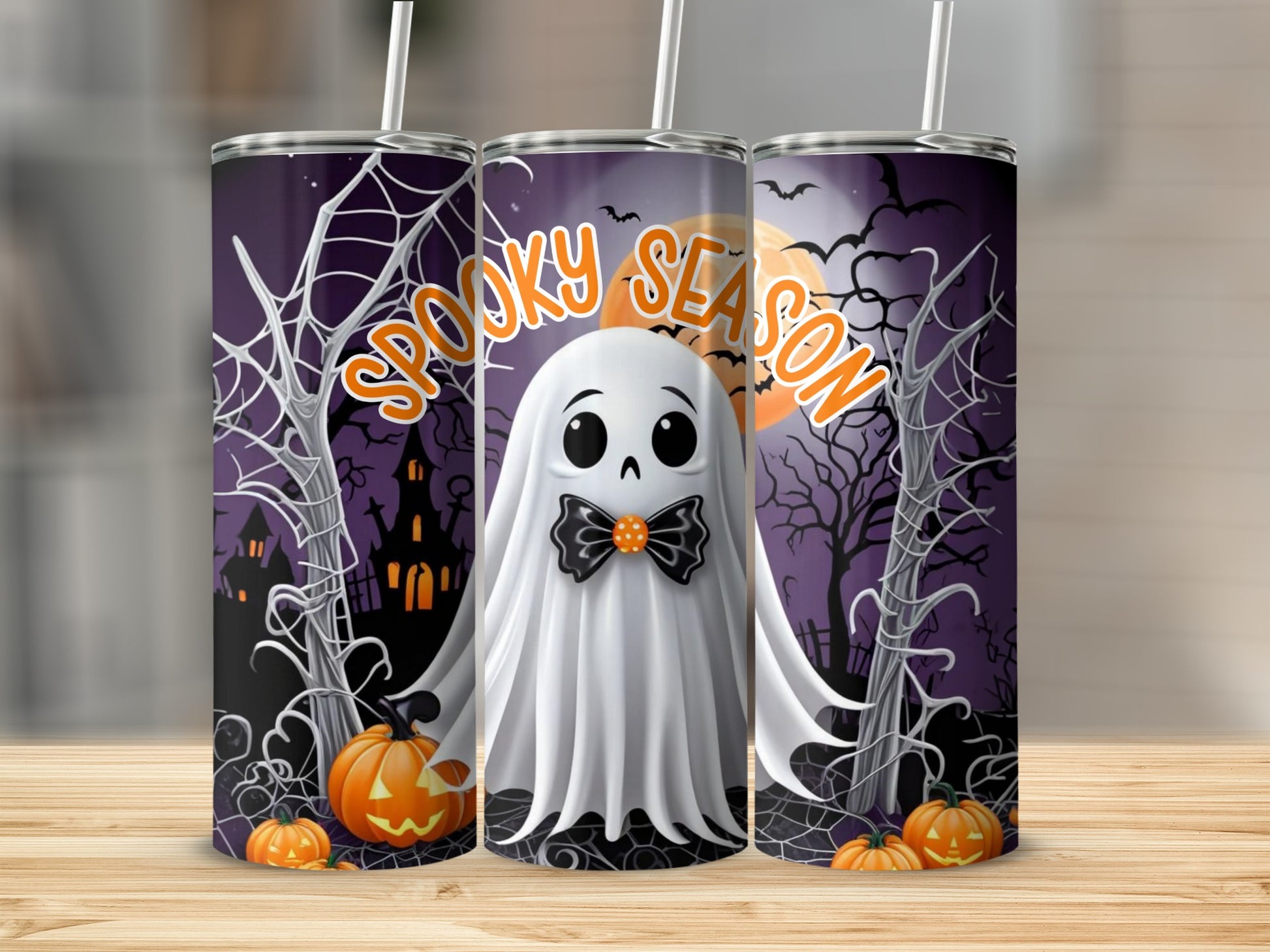 Three tumblers with a spooky Halloween ghost, pumpkins, and haunted house design.