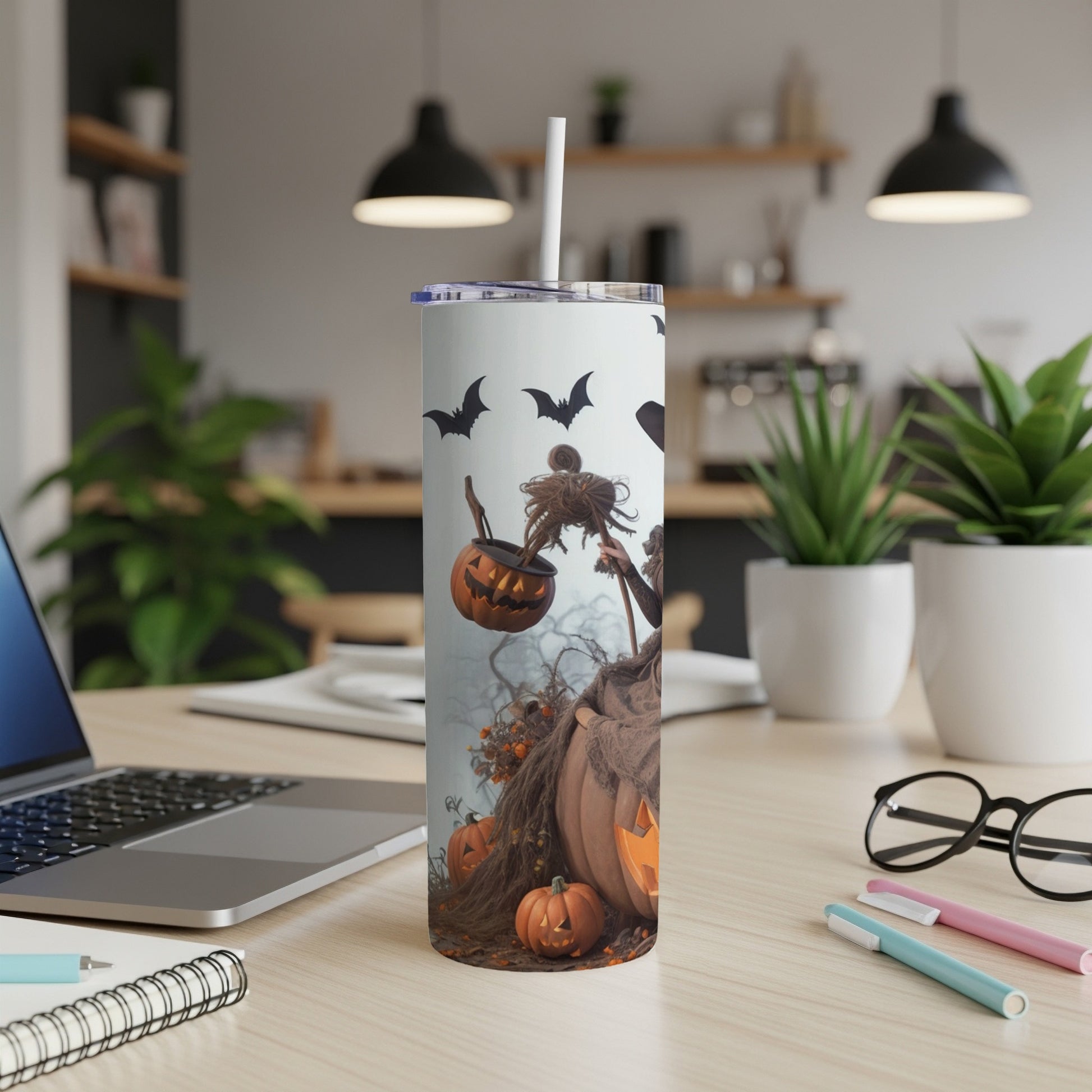 Tumbler with a Halloween design featuring pumpkins, bats, and a witch.