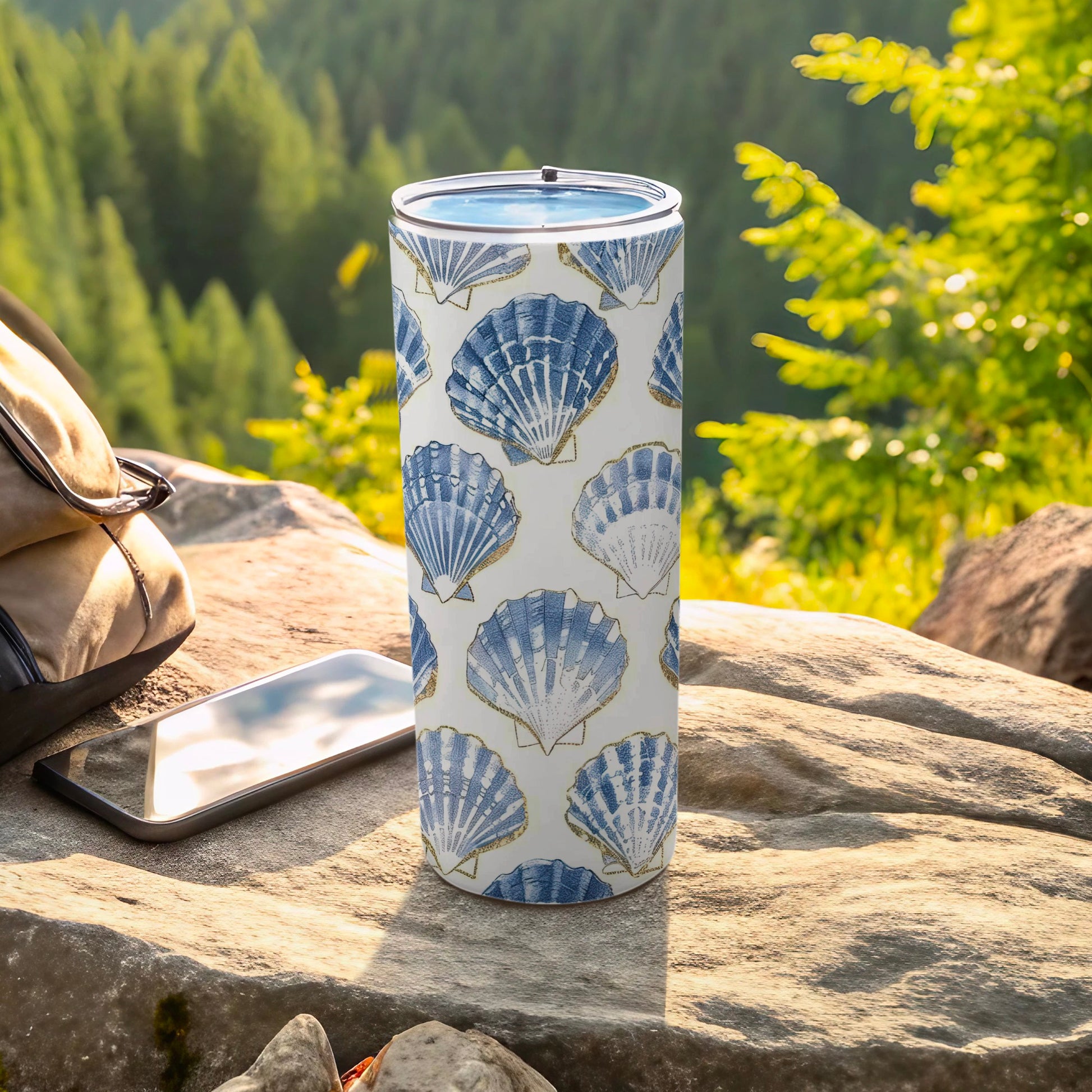 Blue and white seashell patterned tumbler with gold accents.