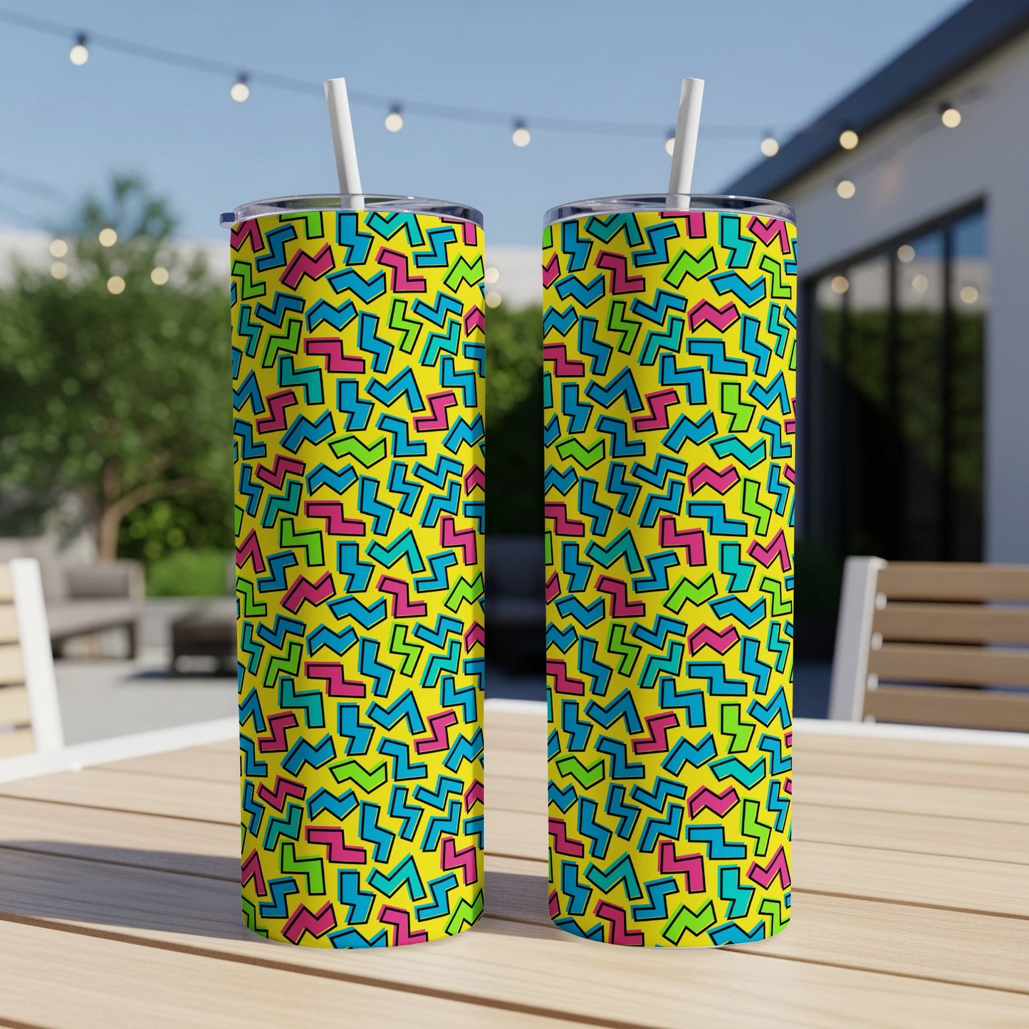 Two tumblers with yellow background and colorful abstract geometric pattern.