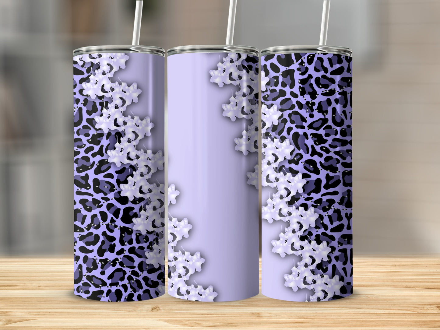 Purple leopard print and white floral design on three tumblers.