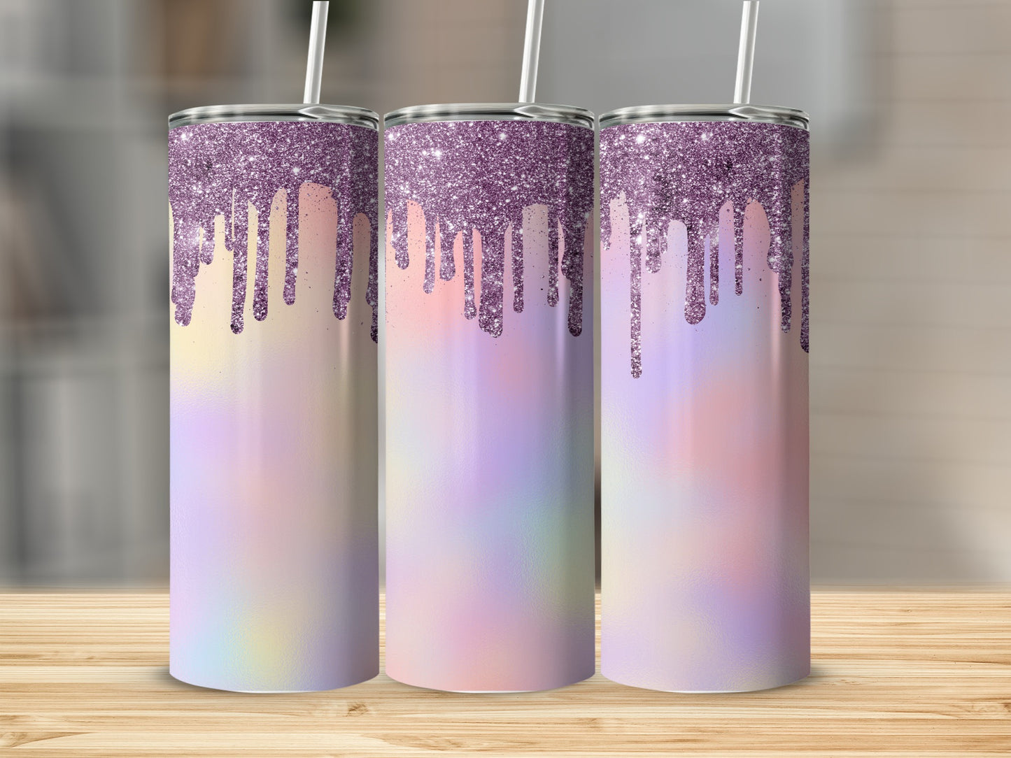 Three iridescent tumblers with dripping purple glitter designs on a wooden surface.