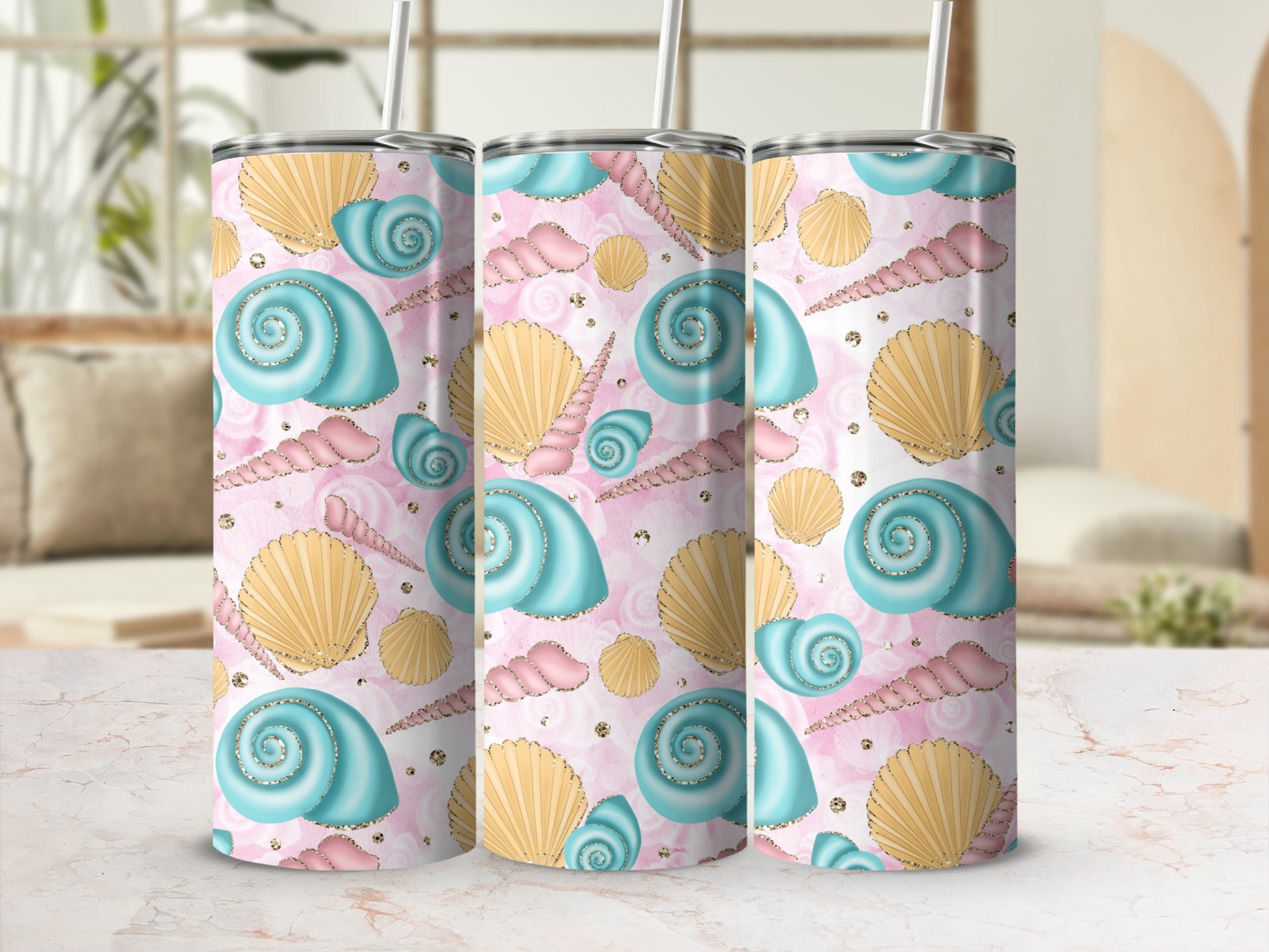Three tall tumblers with a seashell and starfish pattern in blue and pink.
