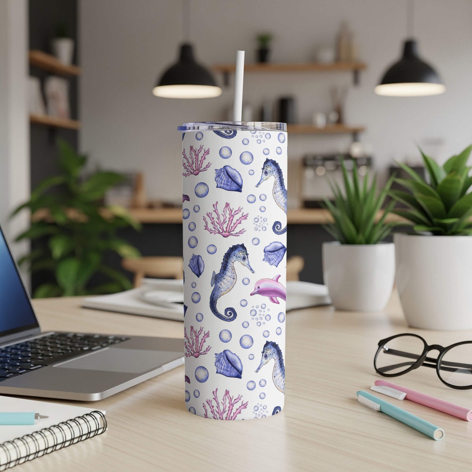 Tumbler with seahorse, seashell, and dolphin pattern.