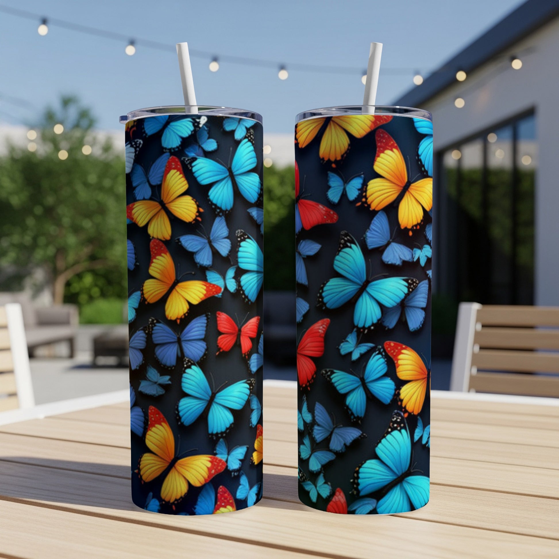 Two tall tumblers with colorful butterflies on a dark background.