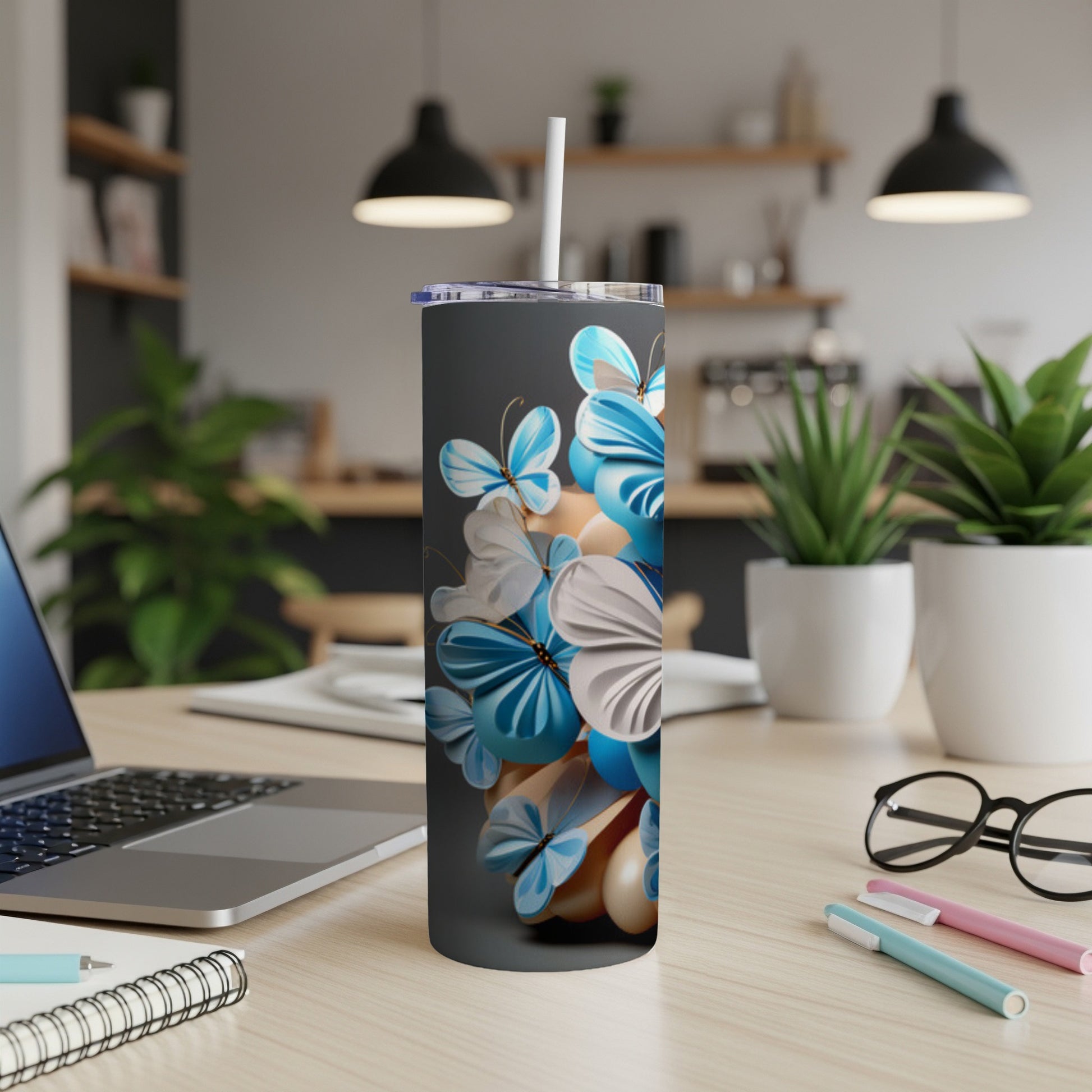Gray tumbler with blue and white butterflies and balloons.