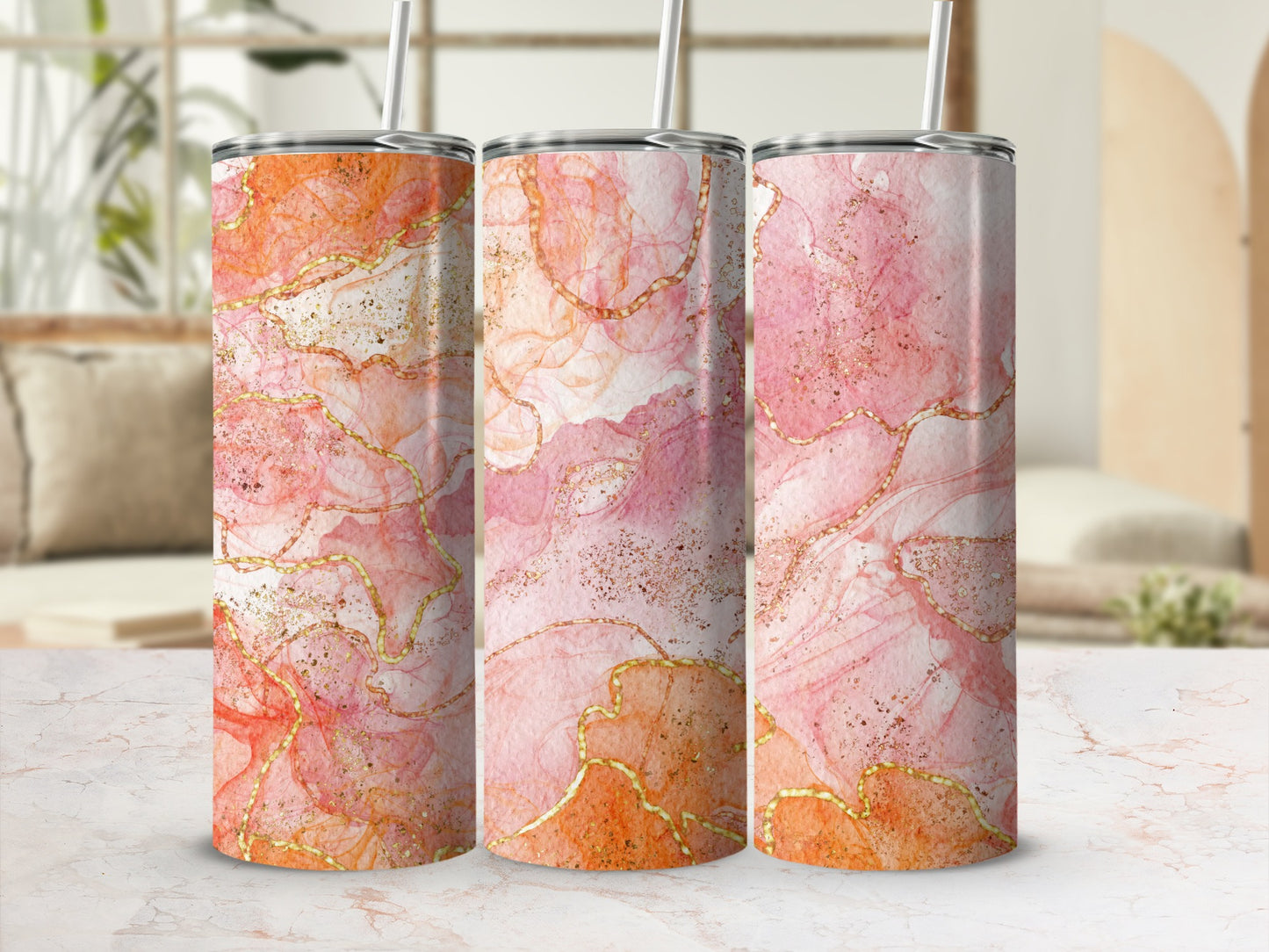 Three tumblers with abstract watercolor art and gold accents.
