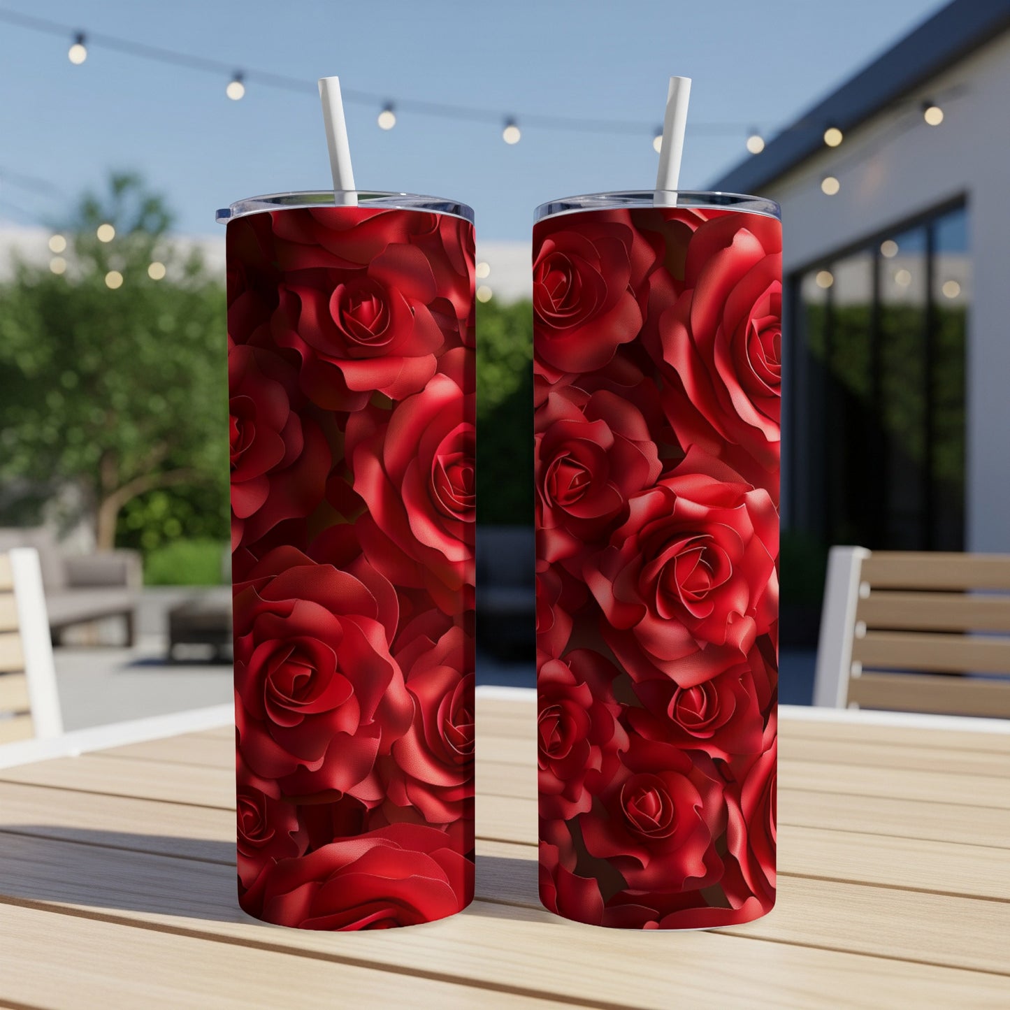 Two tall tumblers with a red rose pattern, sitting on a table.