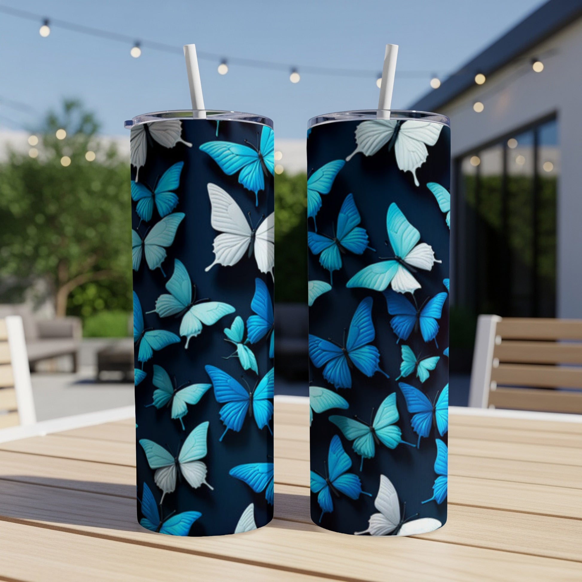 Two blue and white butterfly pattern tumblers on a wooden table.