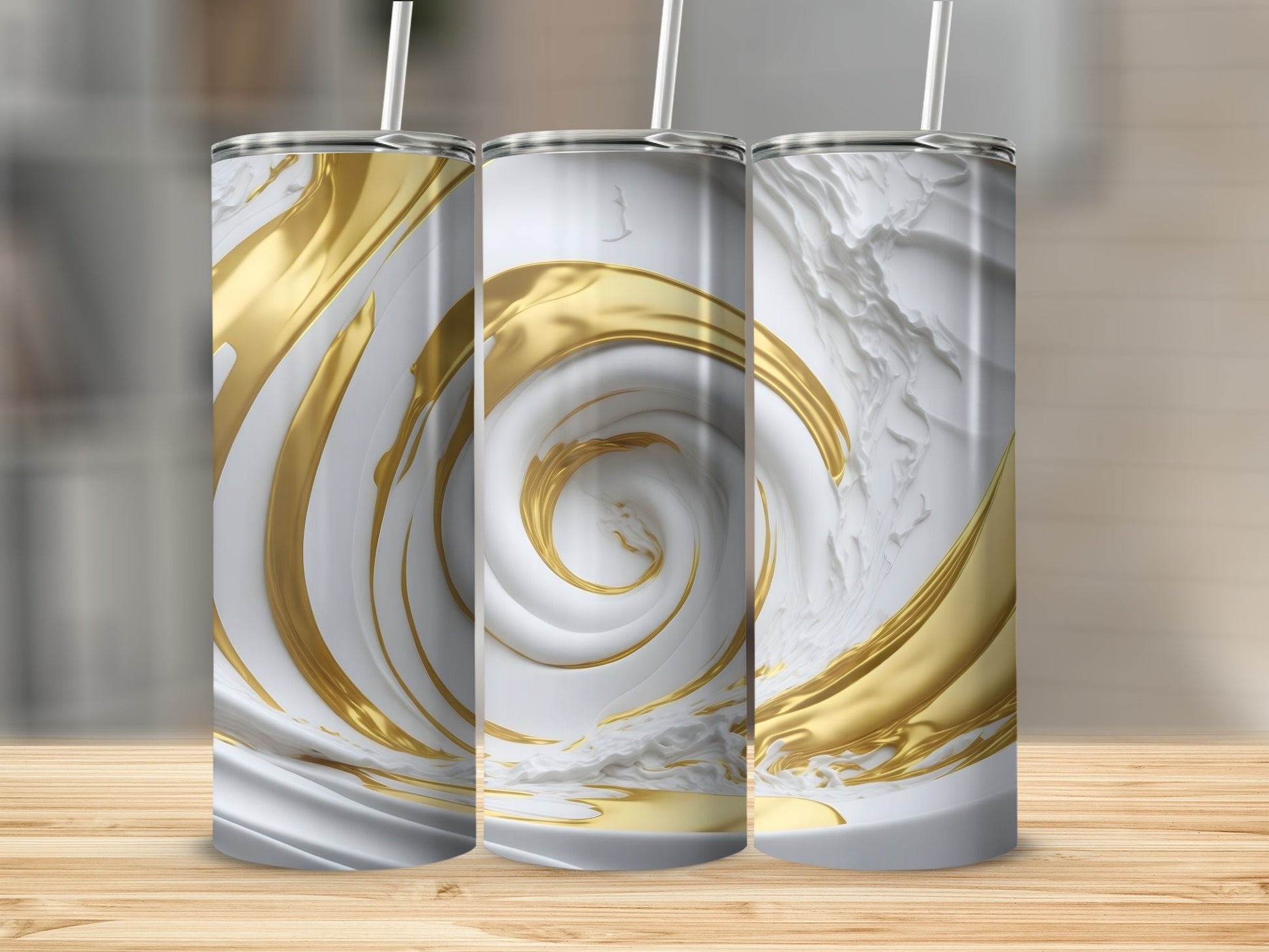 Three white and gold swirling tumblers on a wooden surface.