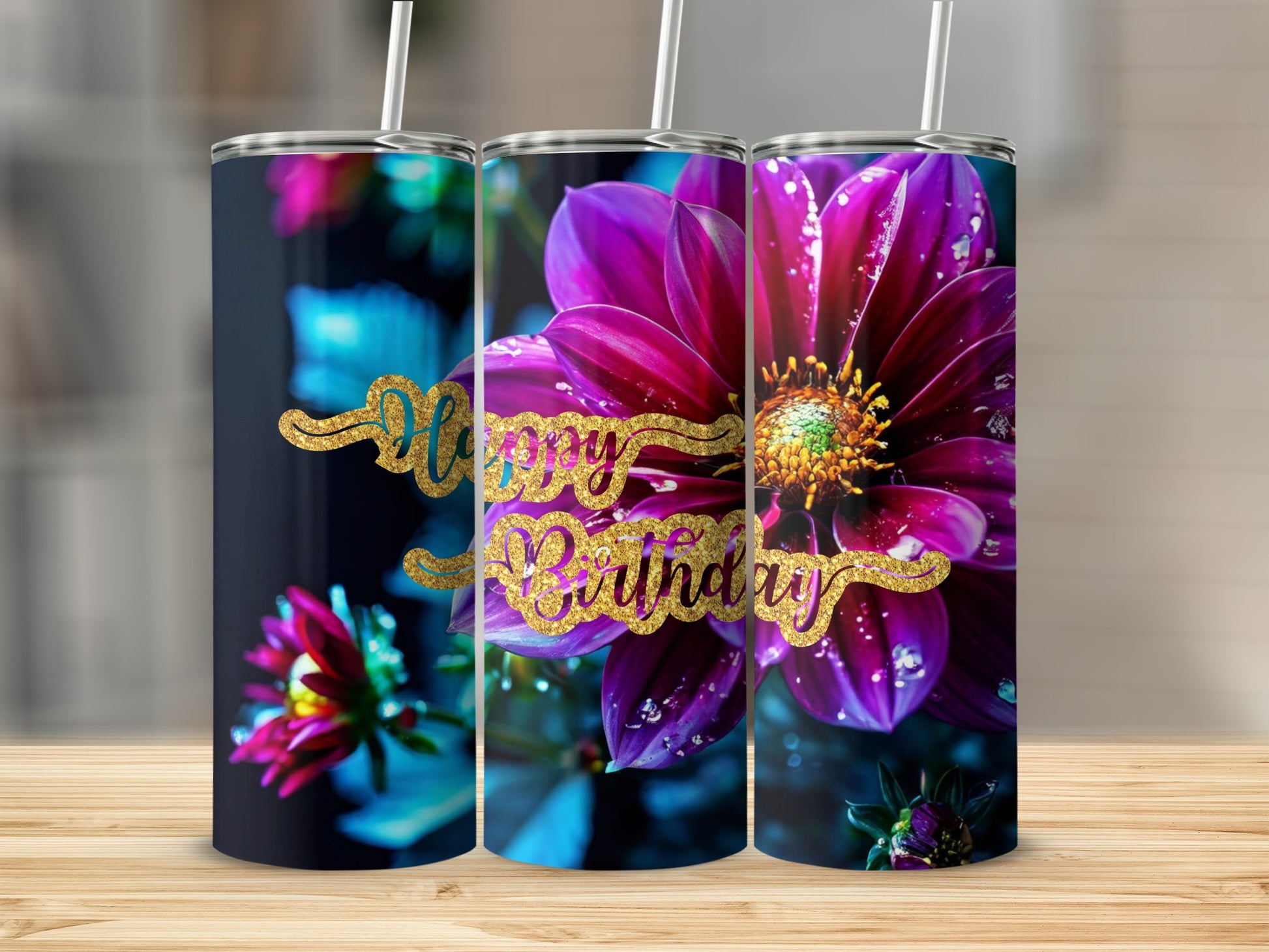 Floral happy birthday tumbler with glitter text on a wooden surface.
