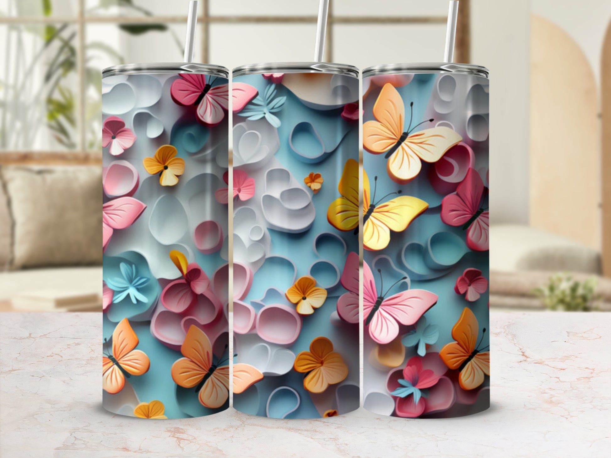 Three tall tumblers with a pastel butterfly and flower design.