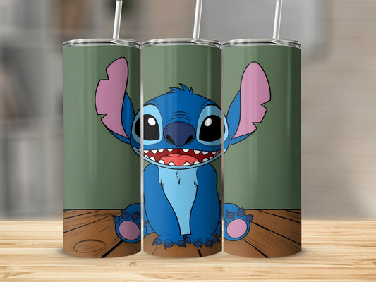 Blue alien character Stitch with big ears and wide smile on wooden surface.
