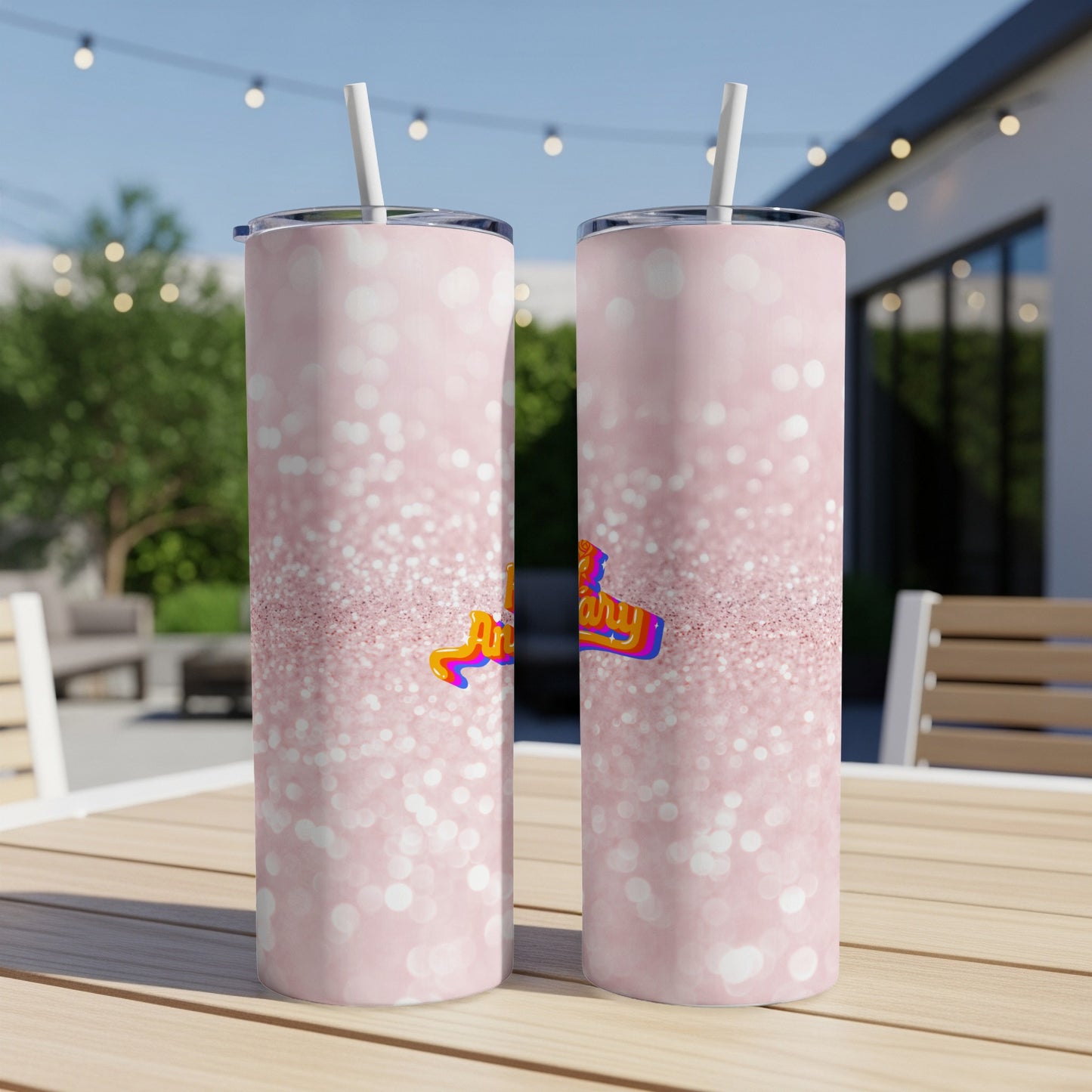 Two pink glitter tumblers with "Happy Birthday" text, on a table.