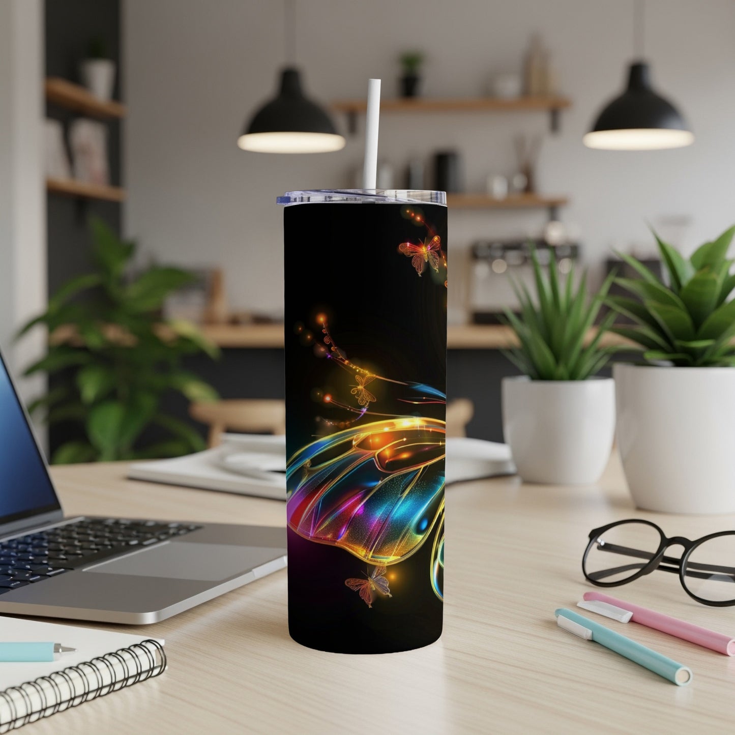Black tumbler with a colorful, glowing butterfly design and white straw.