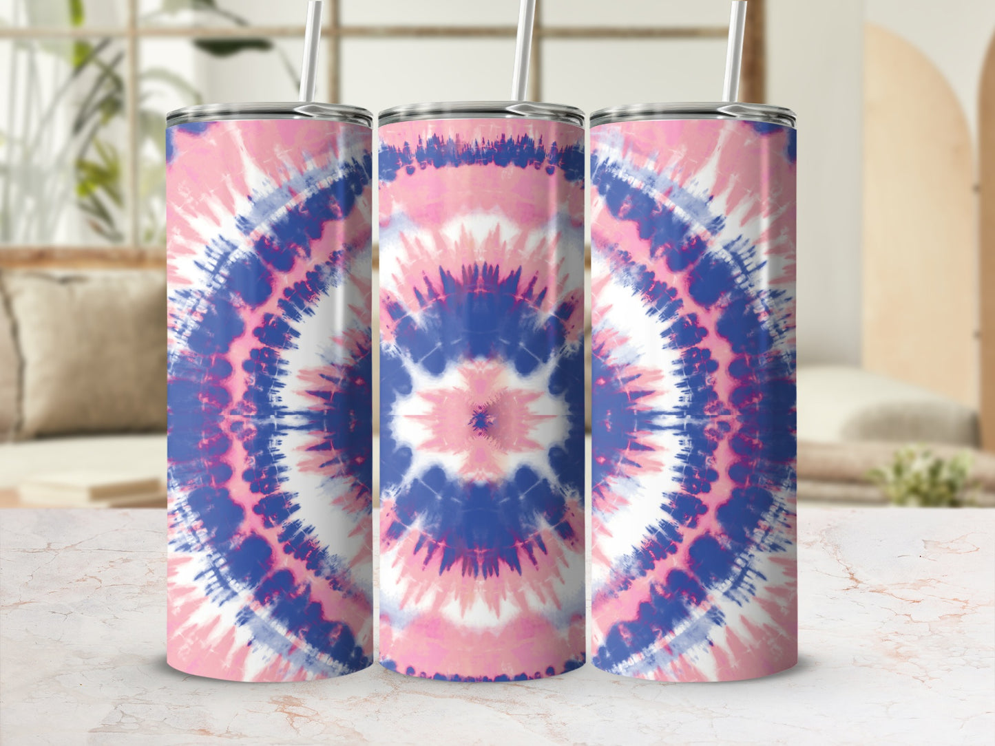 Three tumblers with pink, blue, and white tie-dye pattern and straws.