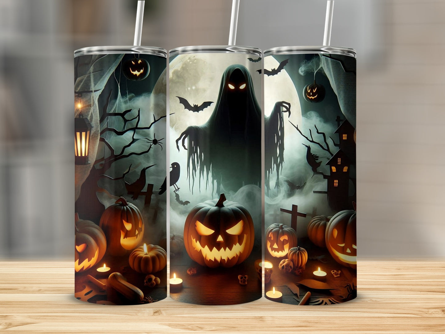 Tumblers with a spooky Halloween scene featuring a ghost, pumpkins, bats, and a haunted house.