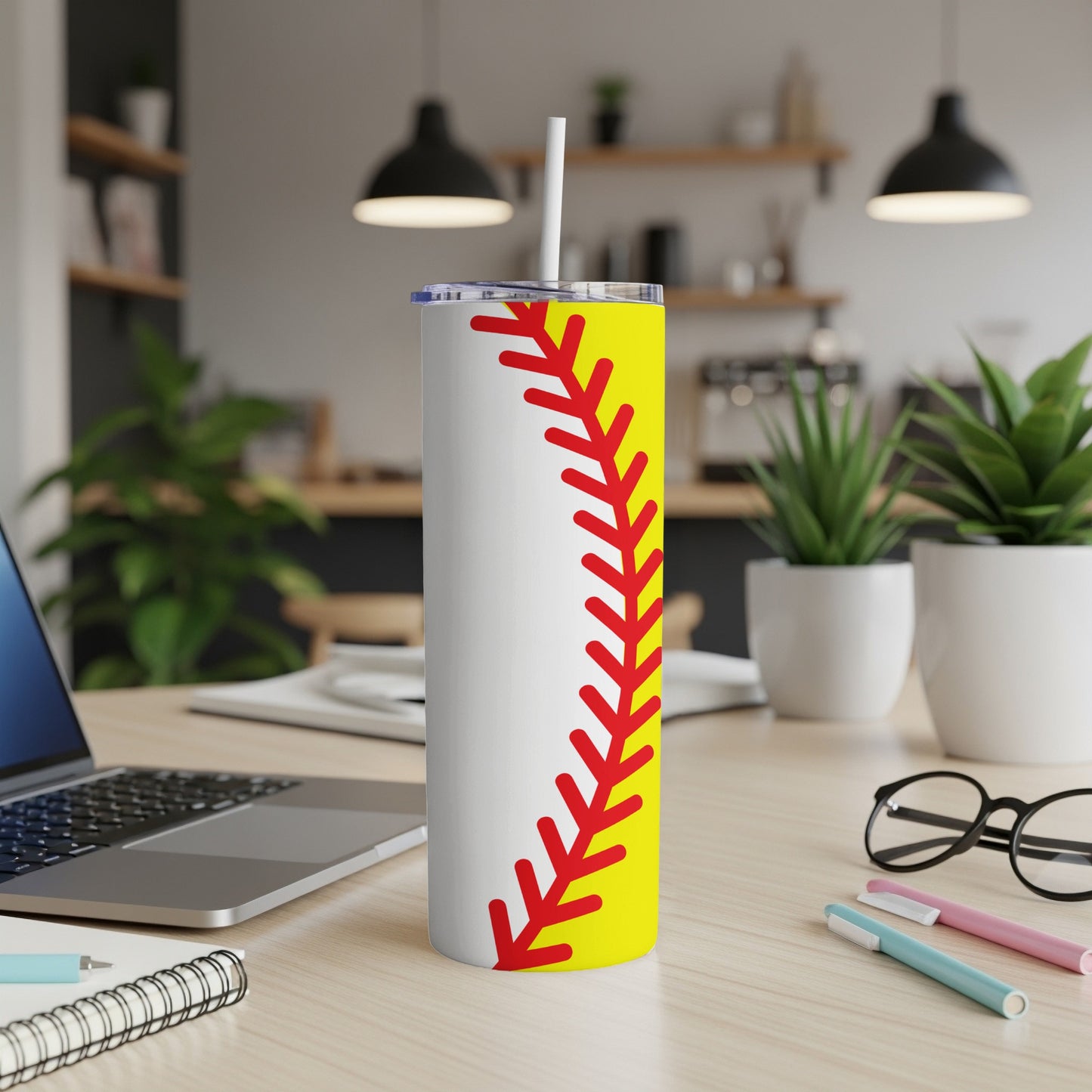 Yellow and red softball seam design on a white tumbler with straw.