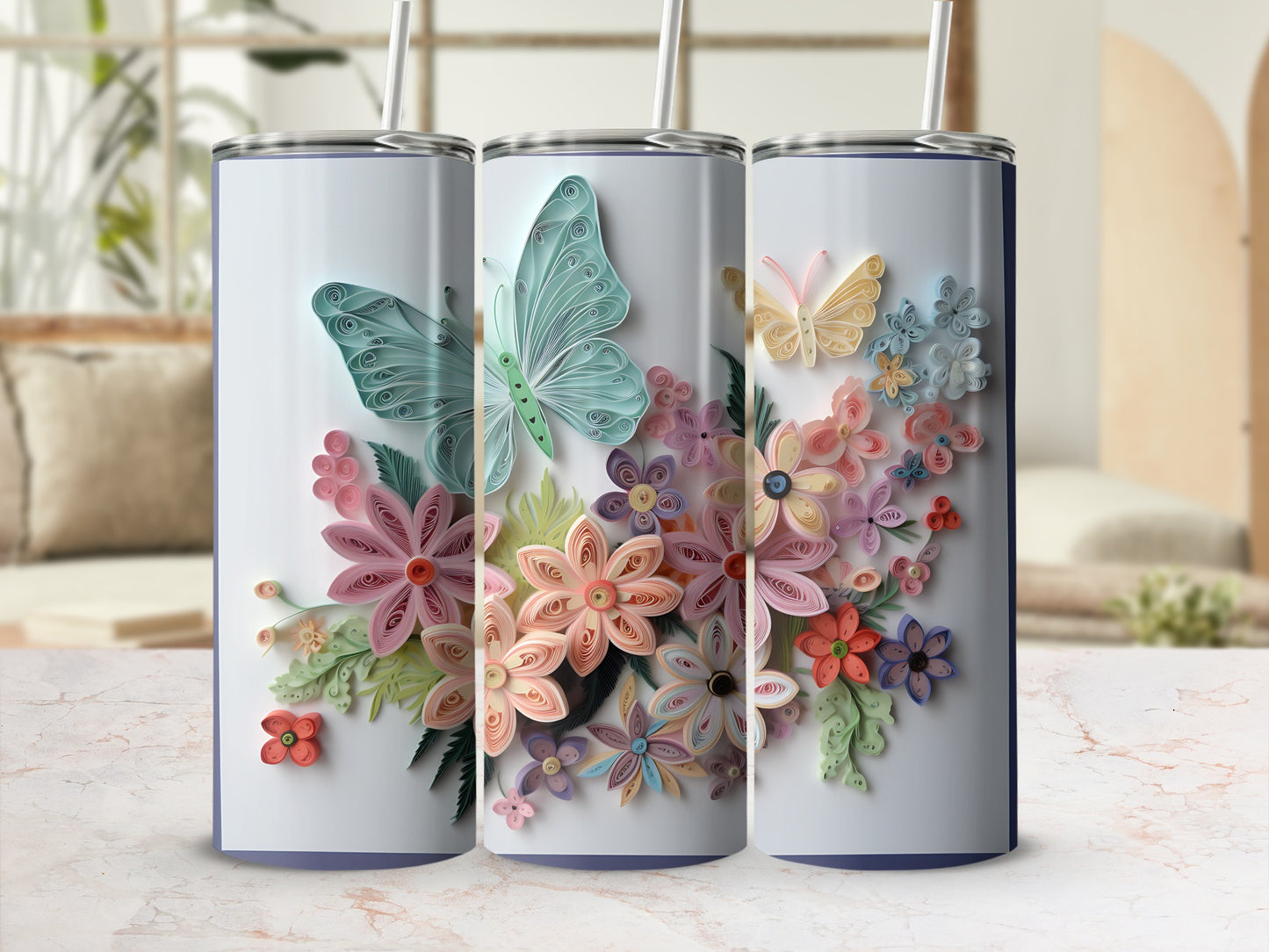 Three tumblers decorated with quilled butterflies and flowers in pastel colors.