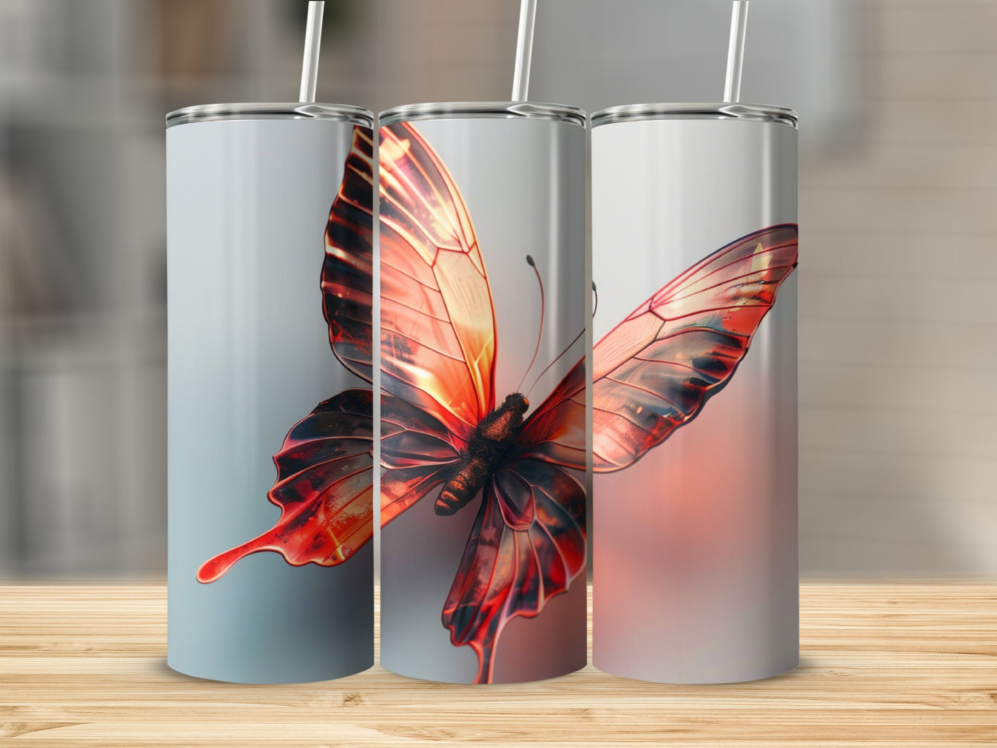 Three tumblers featuring a detailed, glowing orange butterfly design.