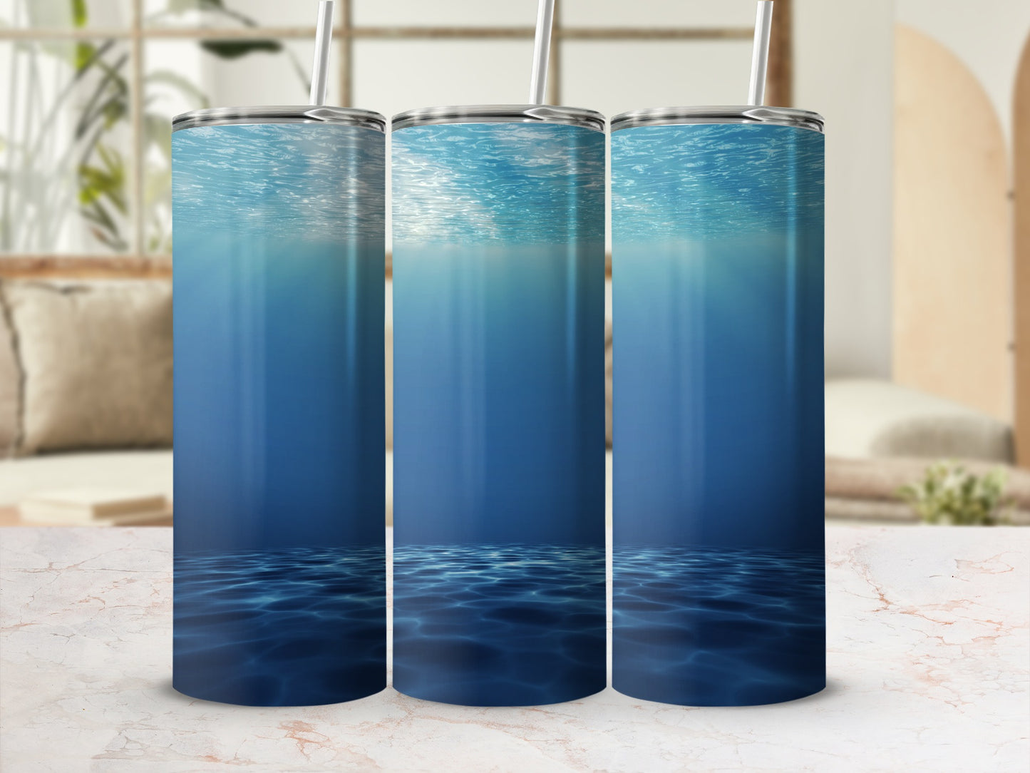 Three tumblers featuring an underwater ocean scene with light rays.