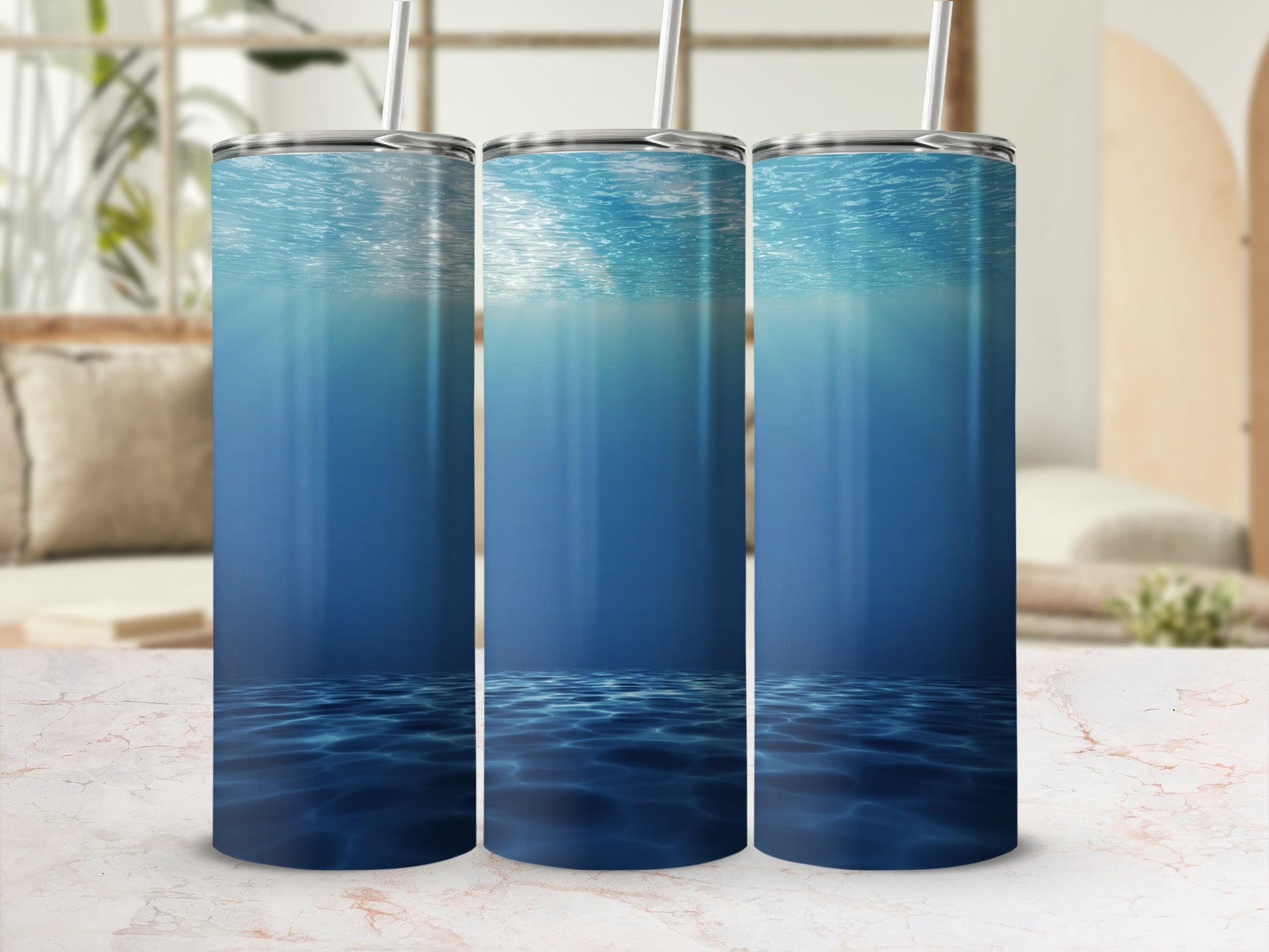 Three tumblers featuring an underwater ocean scene with light rays.