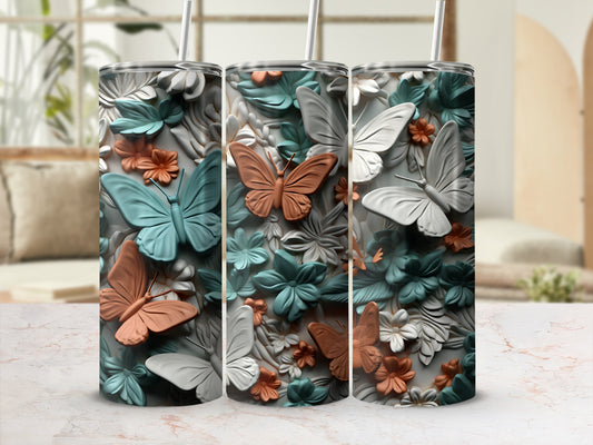 Three tumblers with embossed butterflies and floral designs.