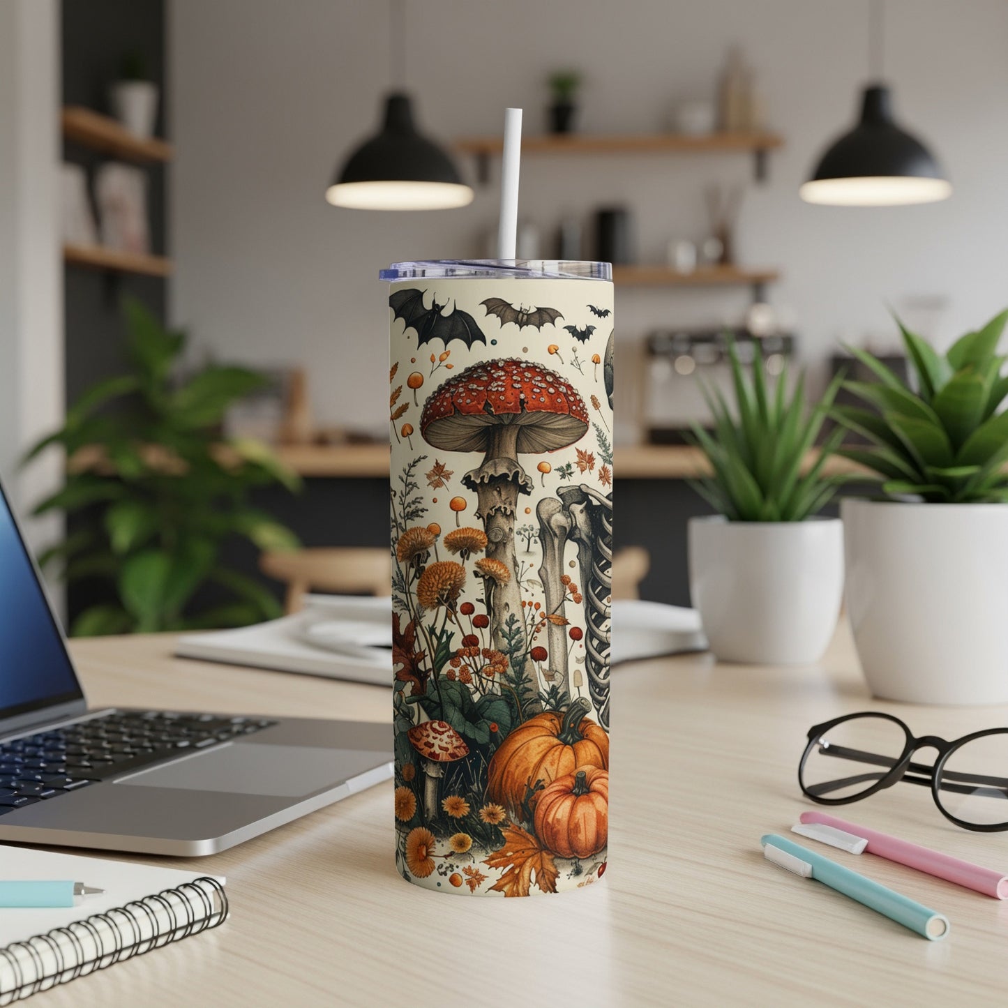 Tumbler with Halloween design featuring mushrooms, bats, skeleton, and pumpkins.