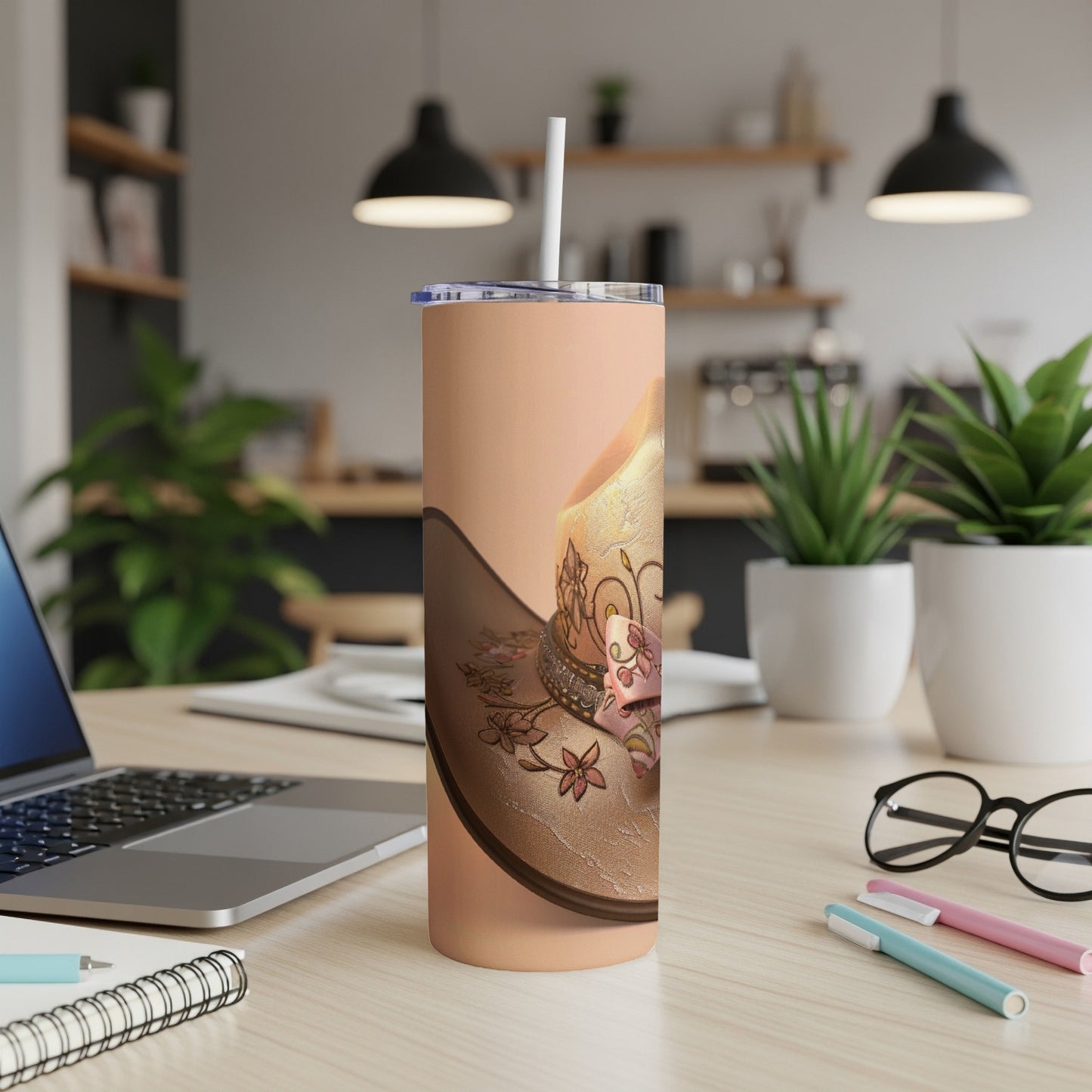 Cowboy hat with pink ribbon on a peach tumbler with straw.