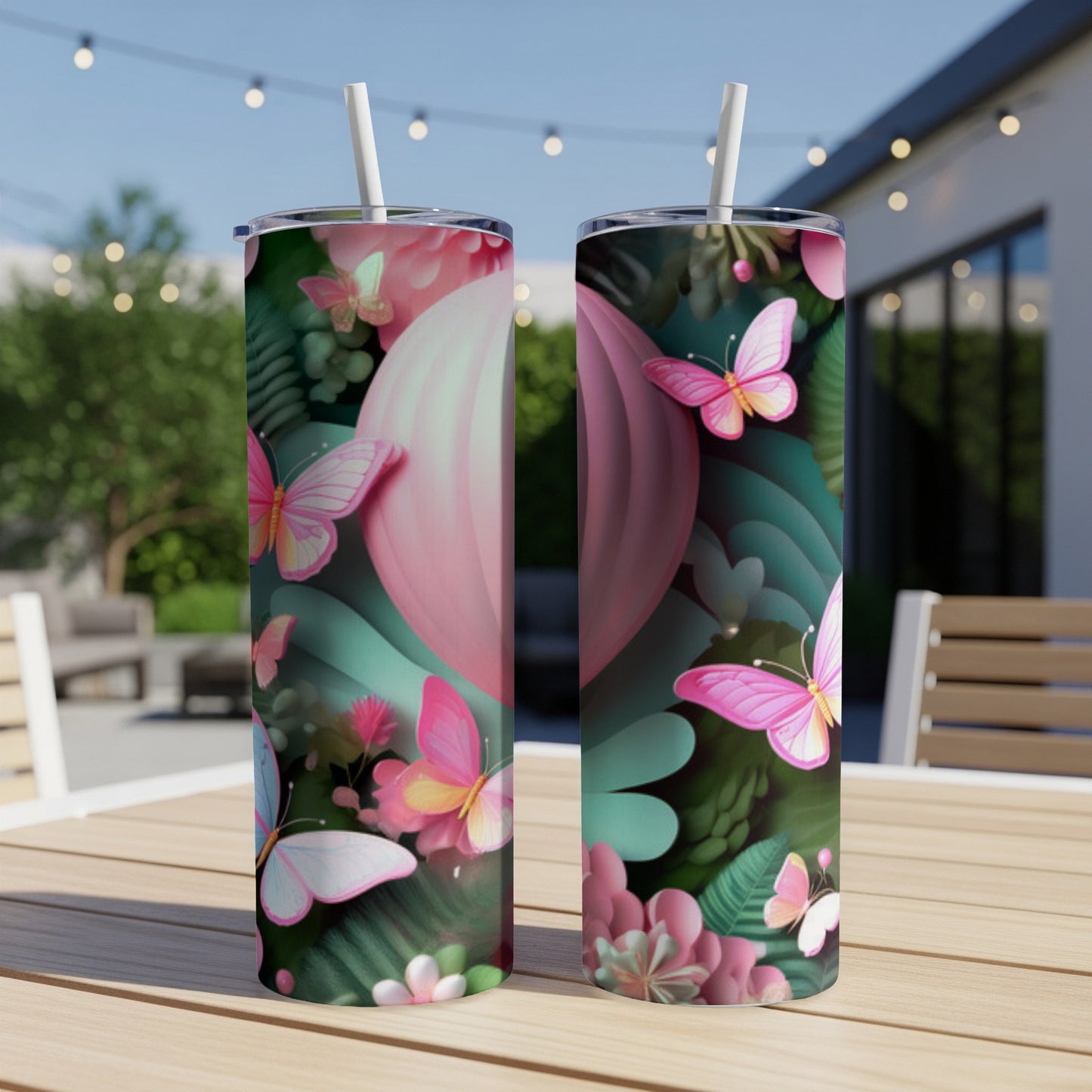 Two pink floral tumblers with butterfly designs on a table.