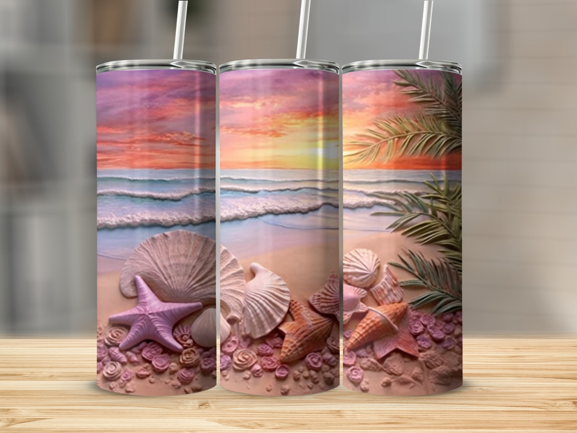 Three tumblers with a beach scene featuring seashells and palm fronds.