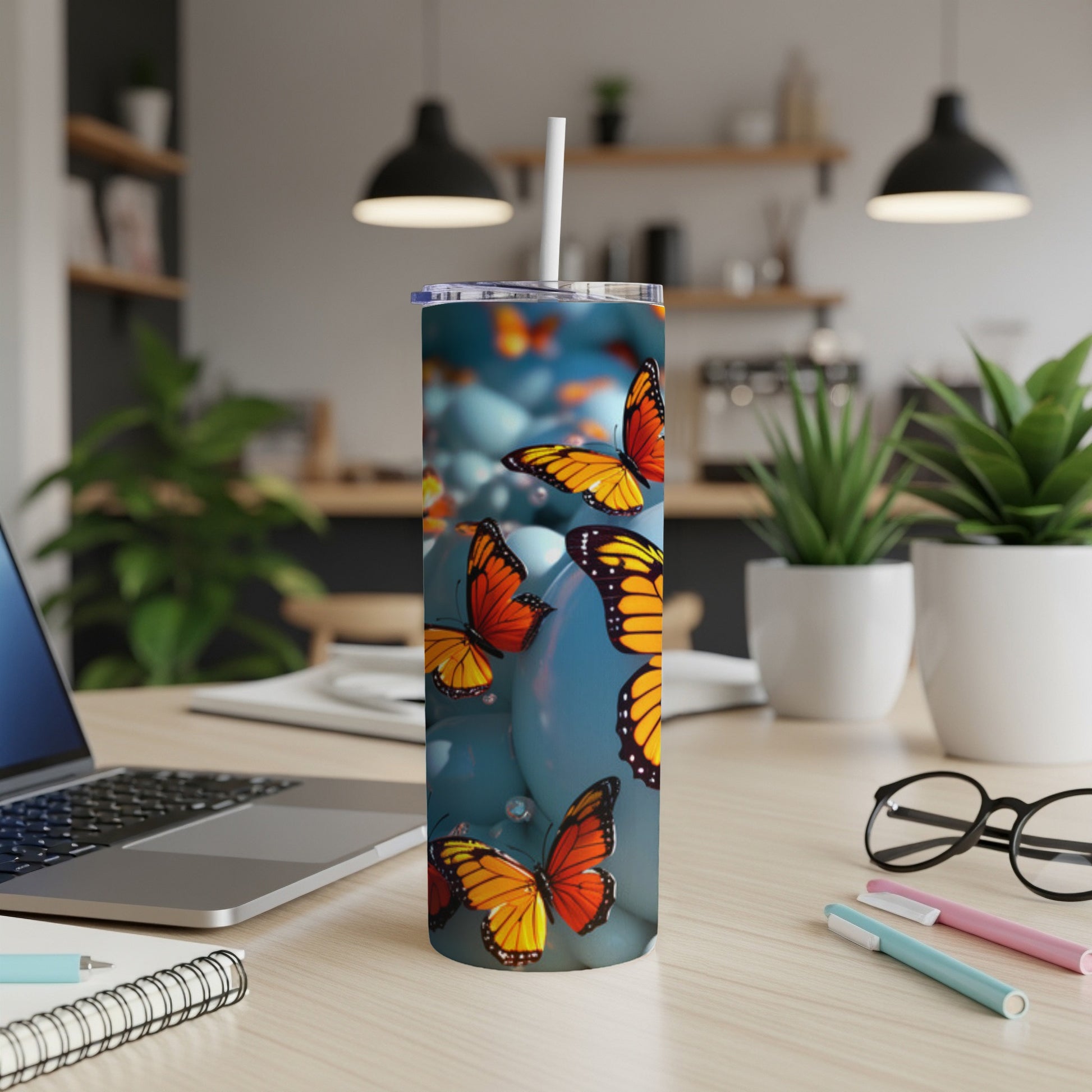 Tumbler with orange and black butterflies on a blue background.
