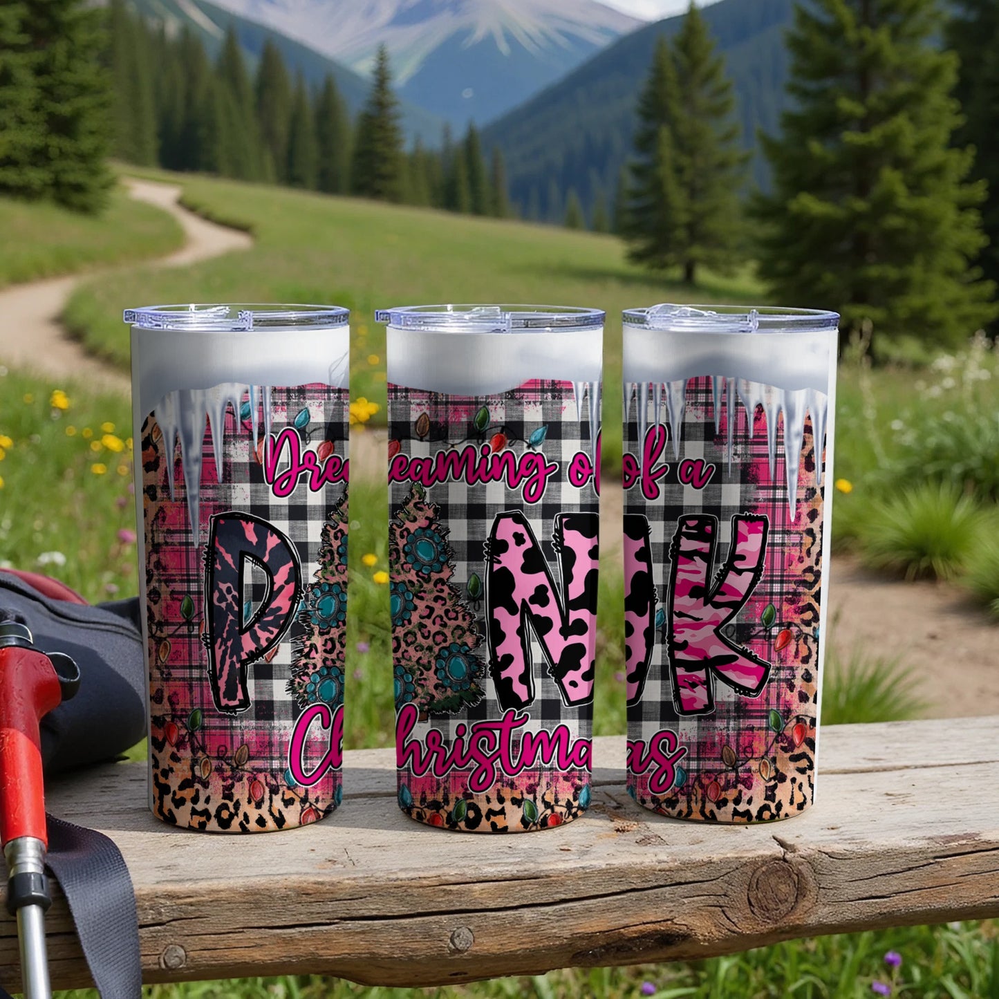Three tumblers with plaid, leopard, and cow print patterns and "Dreaming of a Pink Christmas" text.