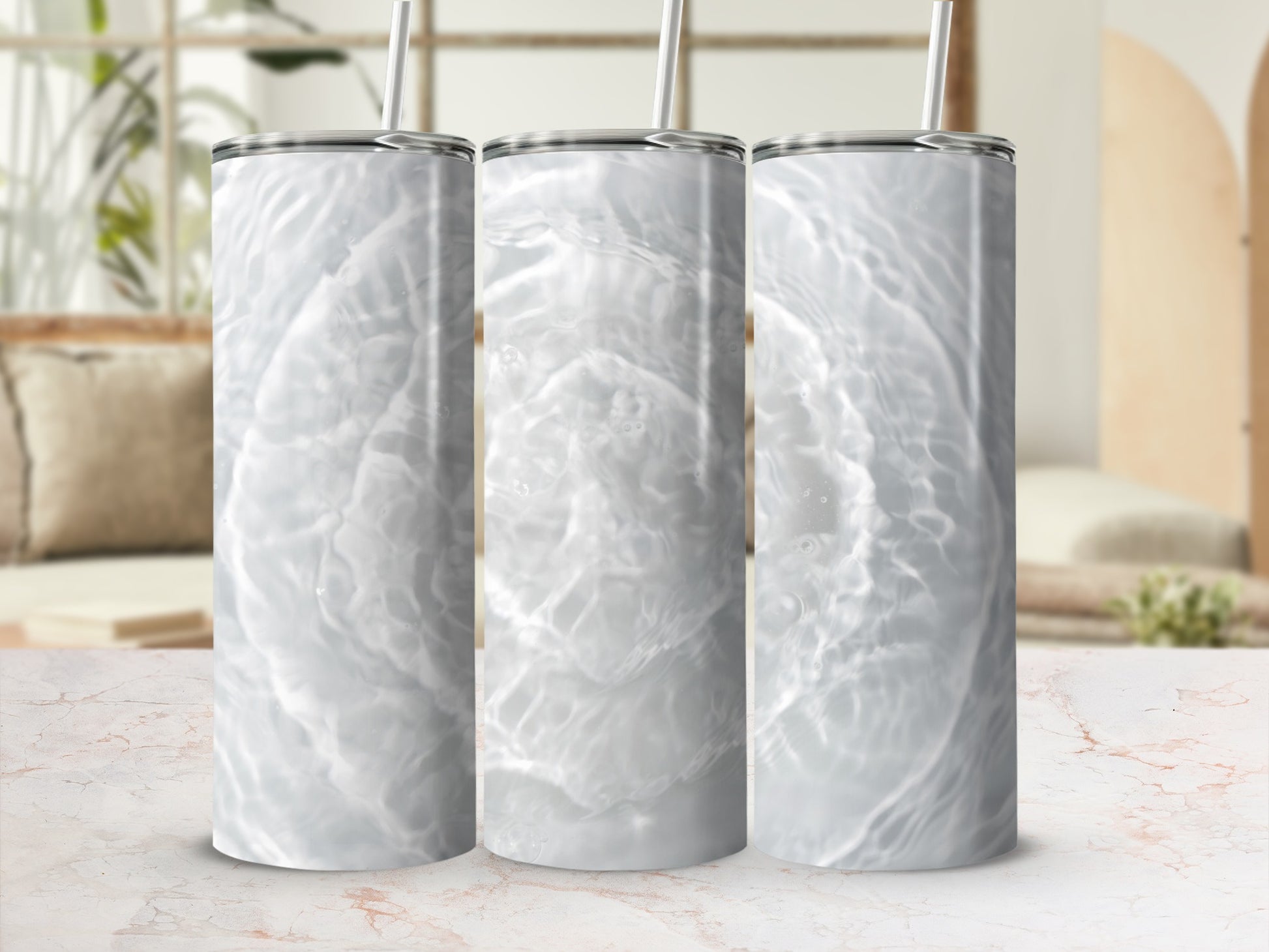 Three tumblers with a ripple water pattern on a marble surface.