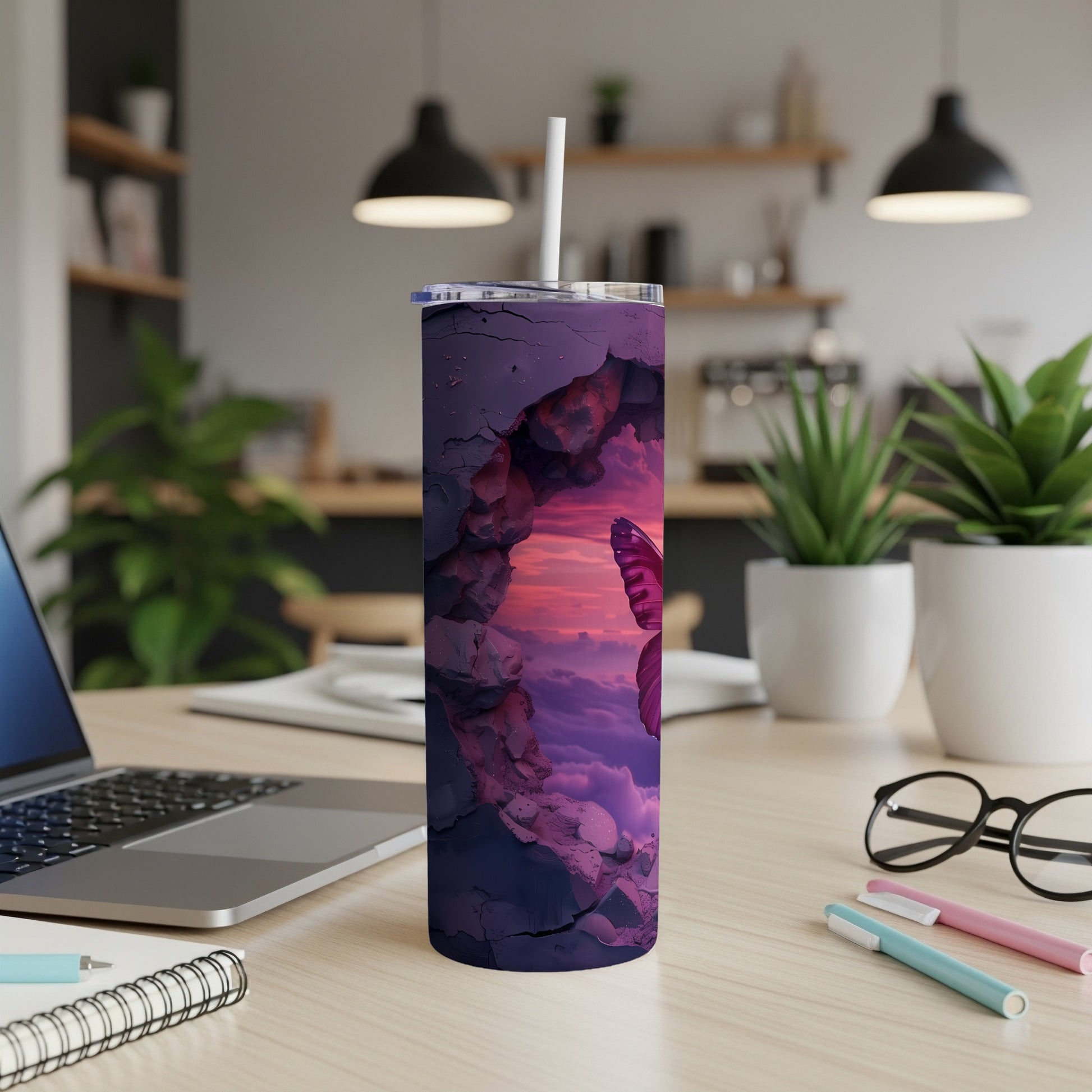 Purple cracked tumbler with butterfly and clouds design, with a straw.