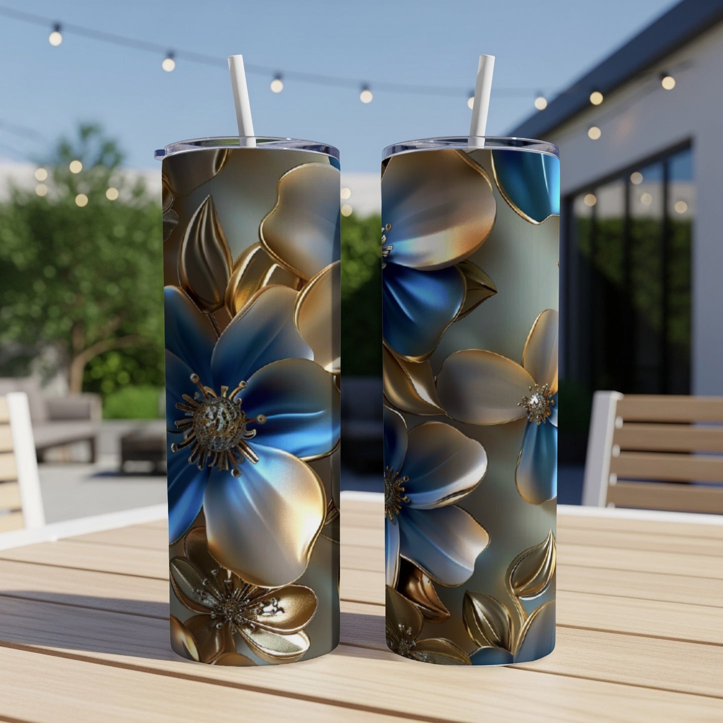 Two tall tumblers with blue and gold floral pattern on outdoor table.